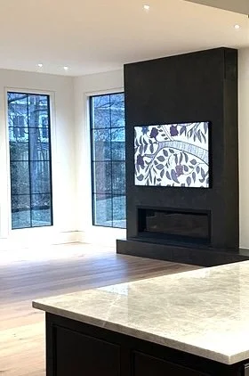 Expansive living room fireplace finished in earthy hand-applied plaster in a modern organic home.