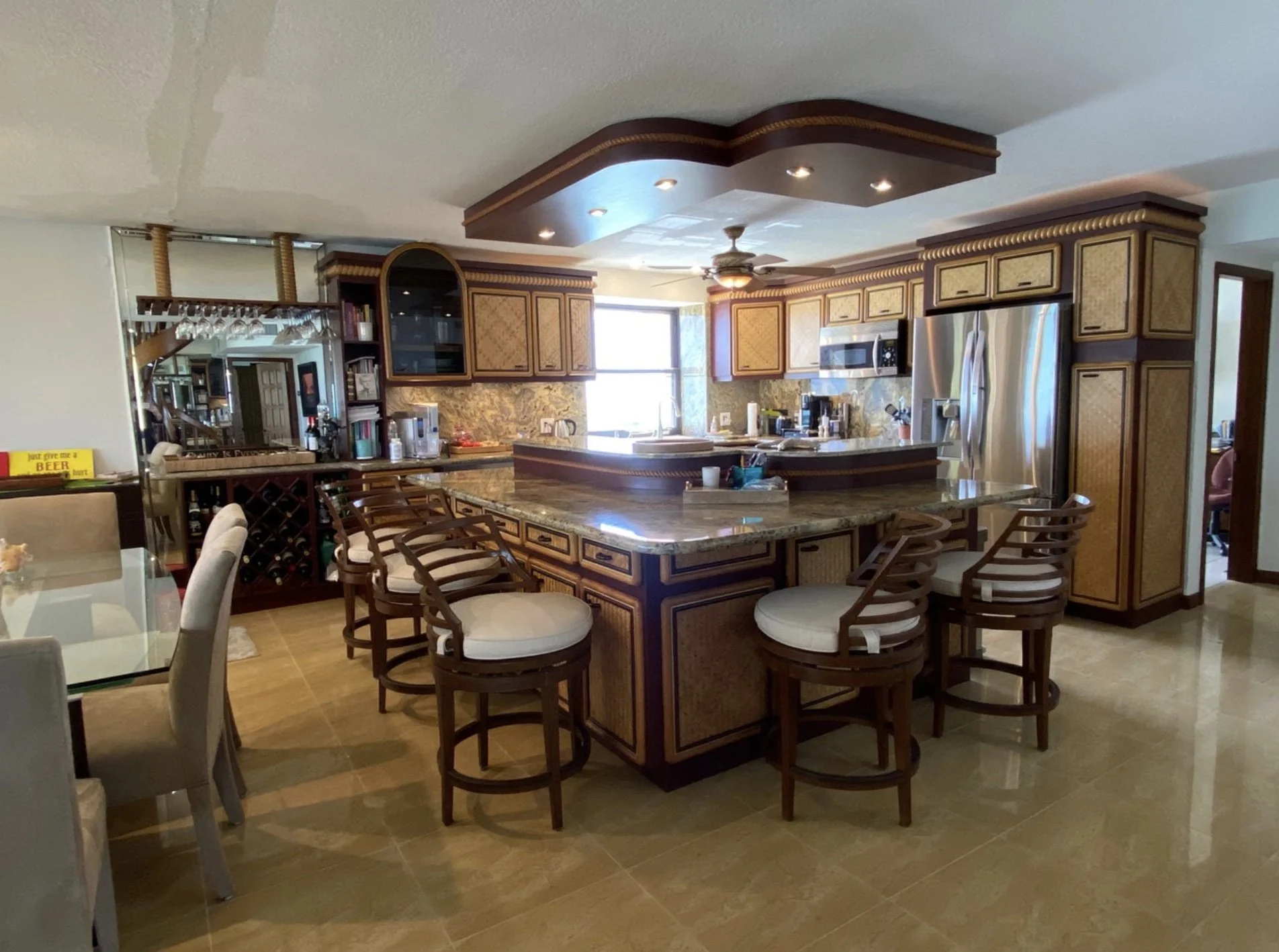 Original dark and dated kitchen of a Key West condo before the Casa Millie team began the reconfiguration and lightening process.