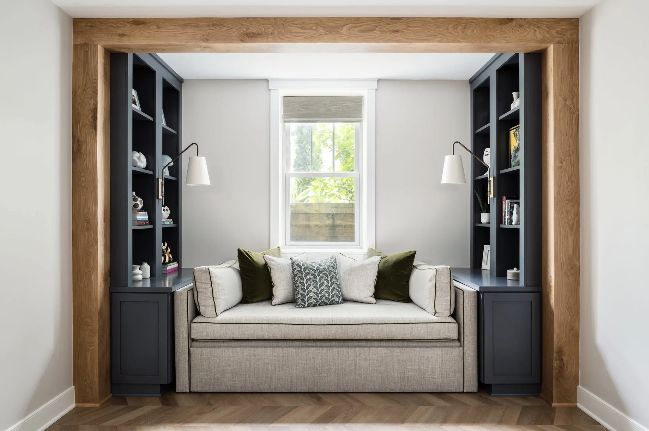 Finished basement remodel in Northern Virginia featuring oak ceiling beams and symmetrical furniture layout for a calming guest sleepovers.