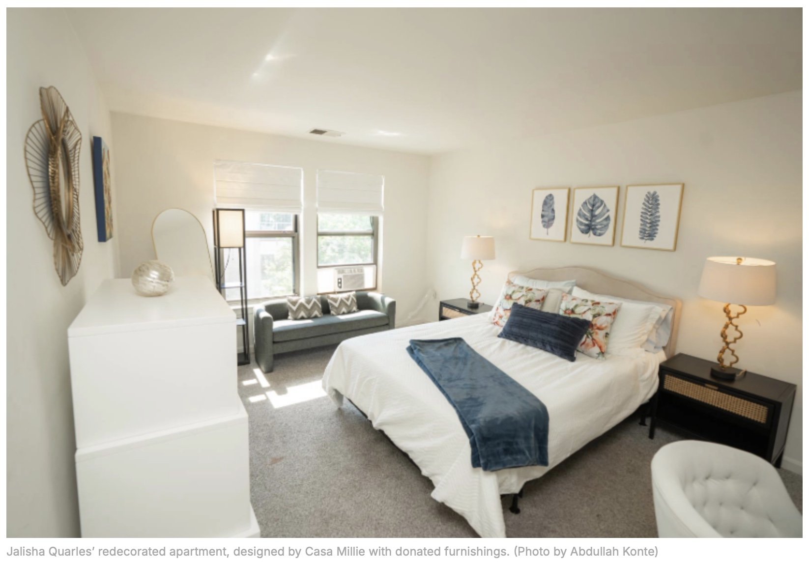 I refurnished sunny apartment bedroom with a white bed and white dresser and small blue sofa.