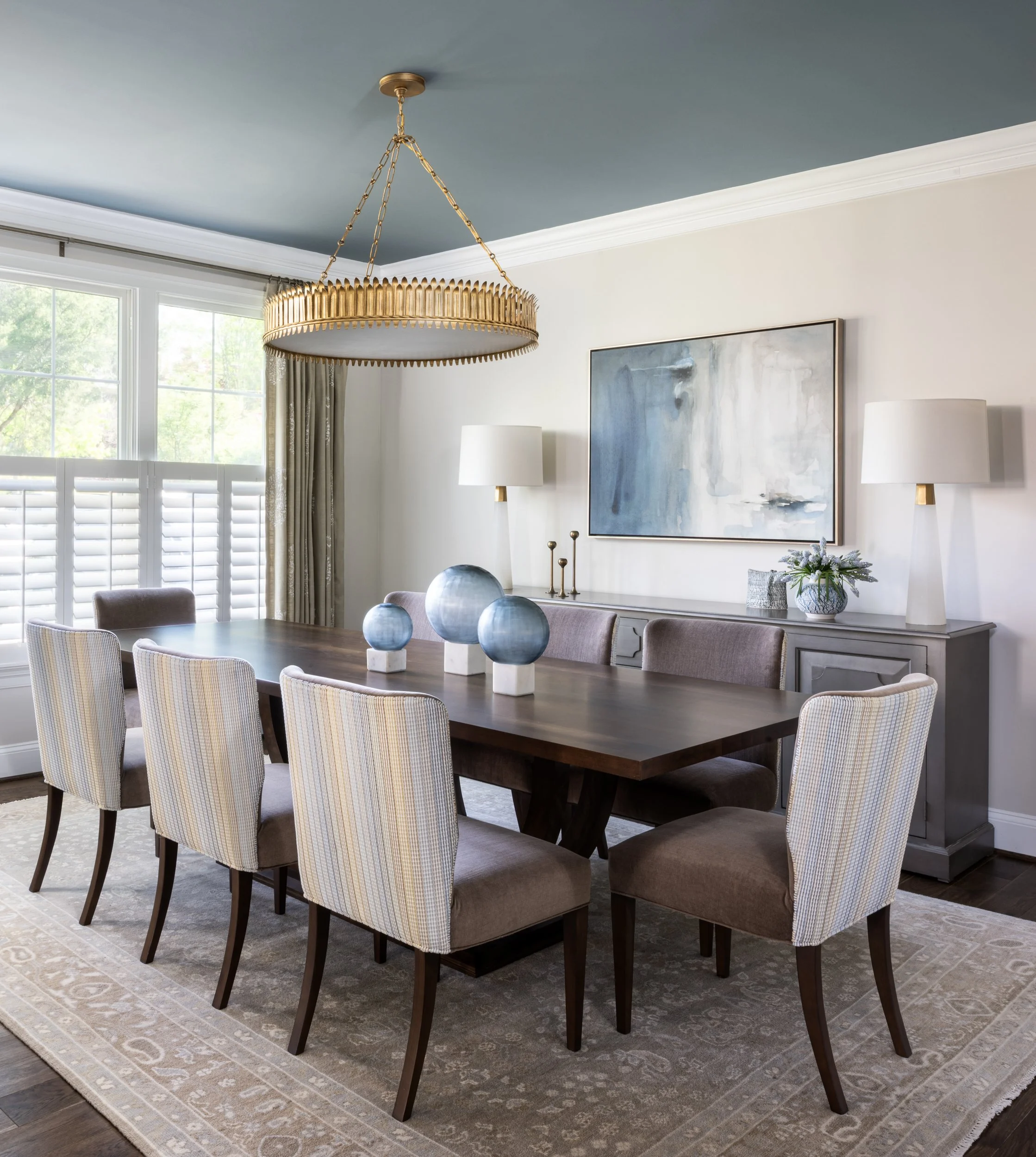The dining room, first designed back in 2015, needed only a lighter touch this time: a new rug, table, chairs, and lighting