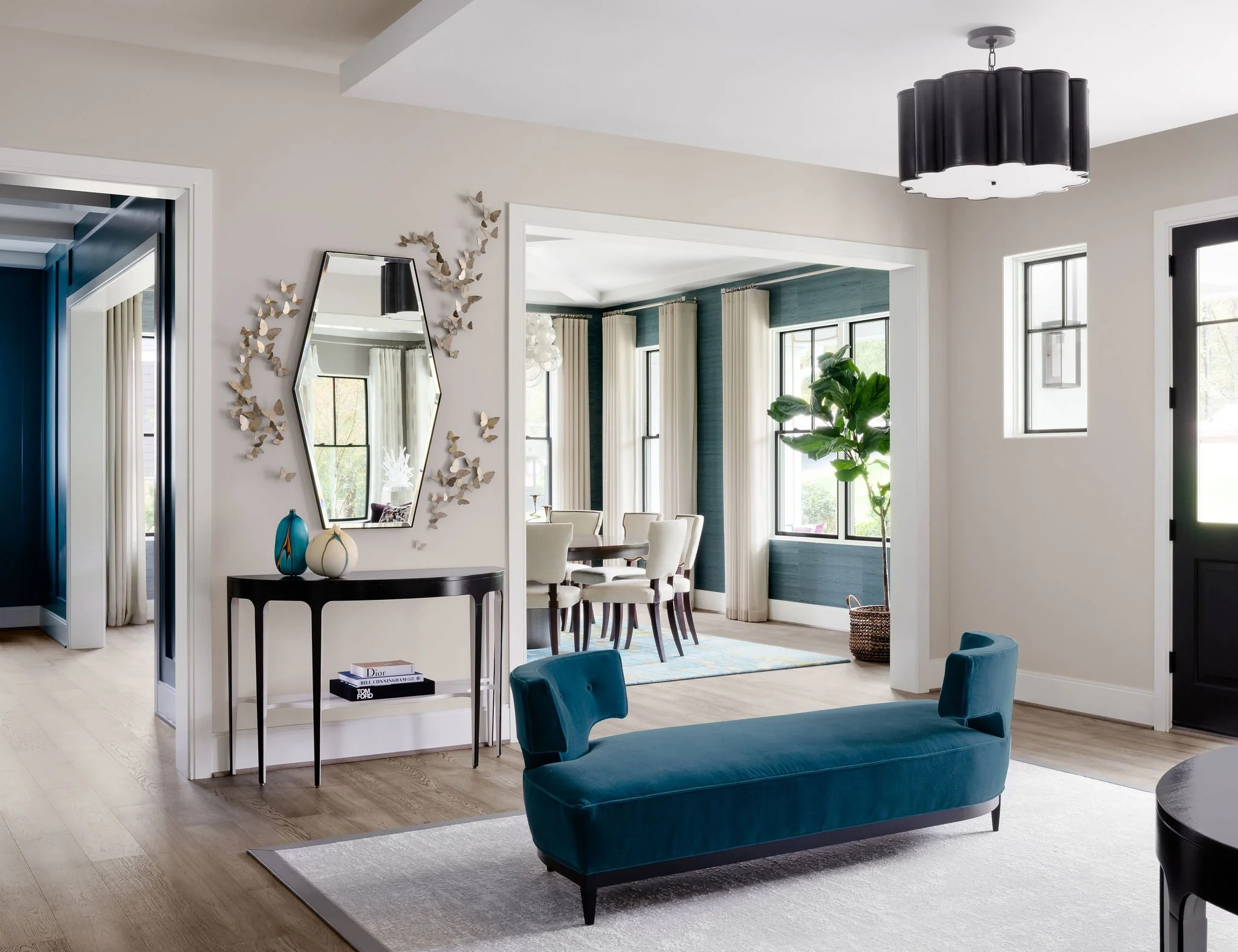 Luxury foyer design featuring an elegant upholstered settee with ample negative space to create a sense of flow and breathing room.