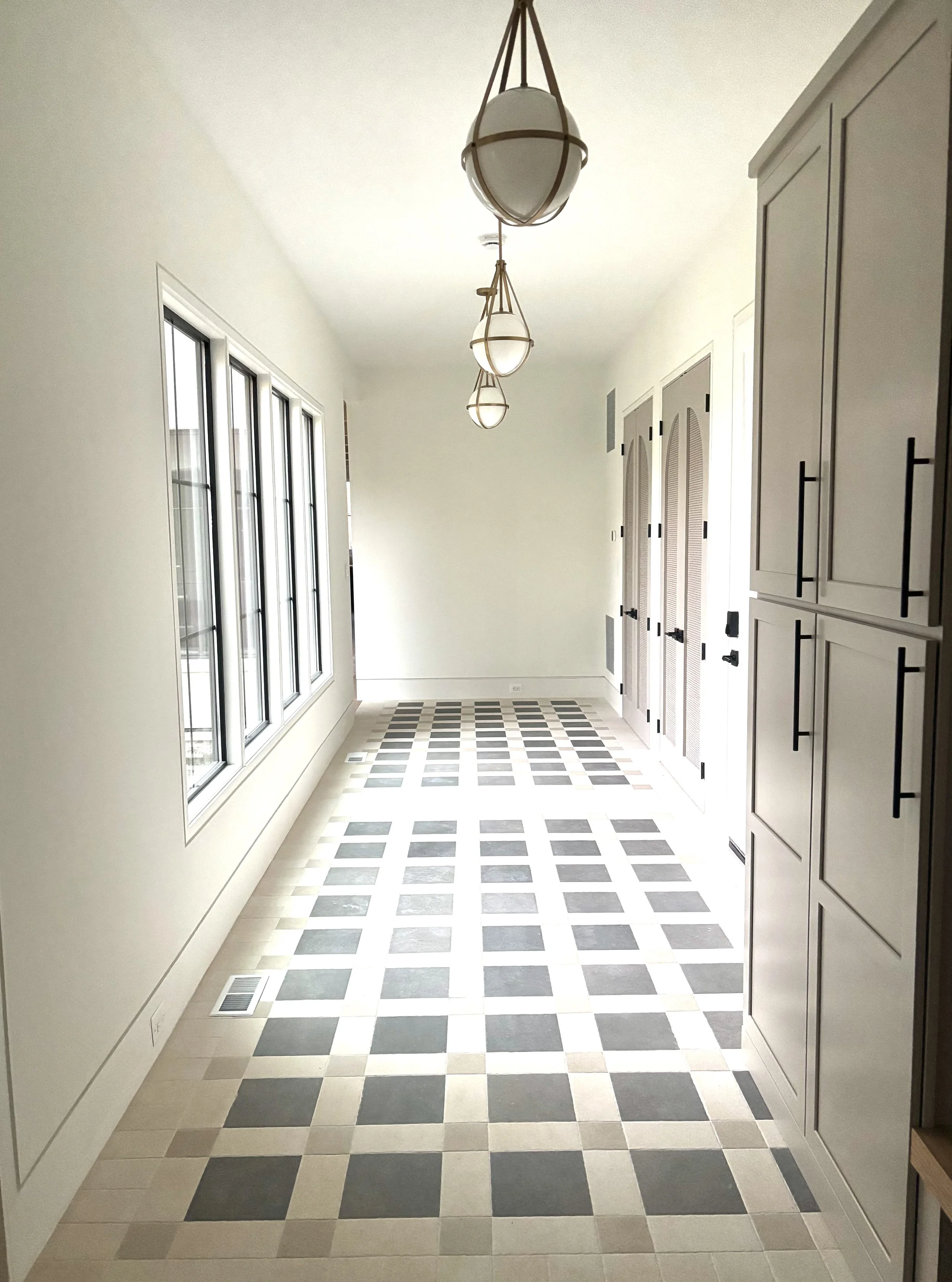 Custom arched interior mudroom doors featuring inset breathable caning for a modern organic look.