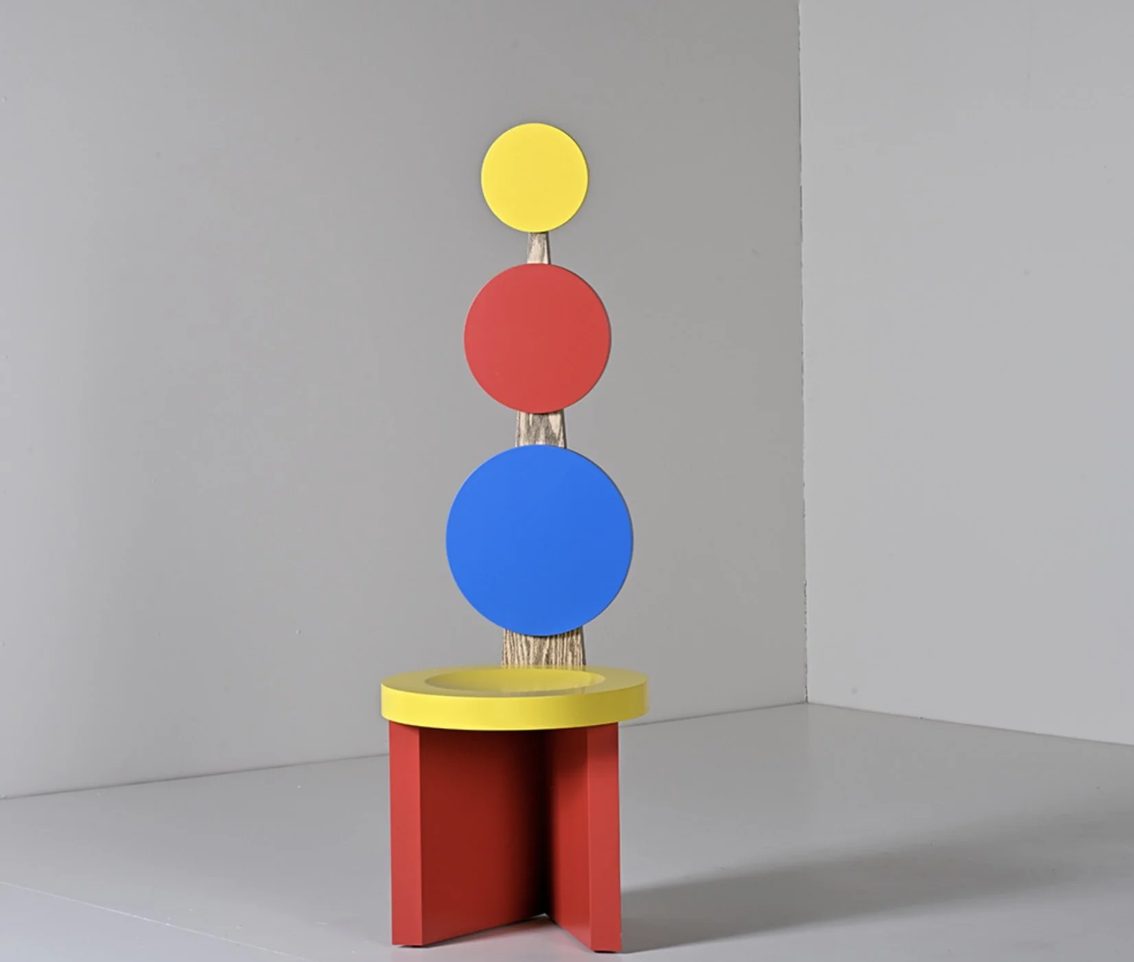 he Gloria Side Chair by Abner Henry featuring a bold orange frame and unconventional post-modern geometric form.