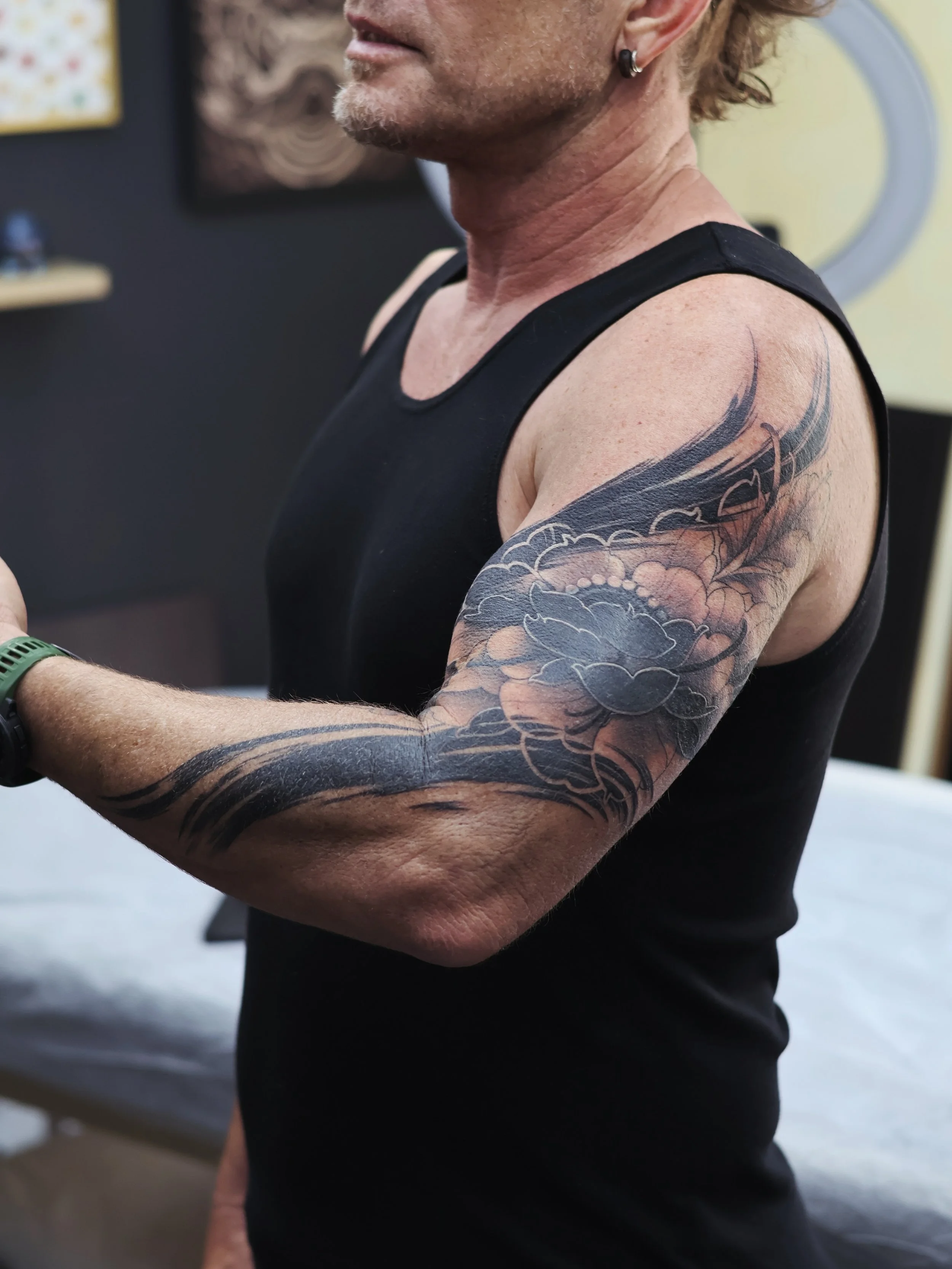 Corbin came to me with a simple brief: cover up an existing tattoo using blackwork and brushwork and gave me creative freedom with the placement.

This is where we landed.

During the design process I presented two concepts. Both successfully covered