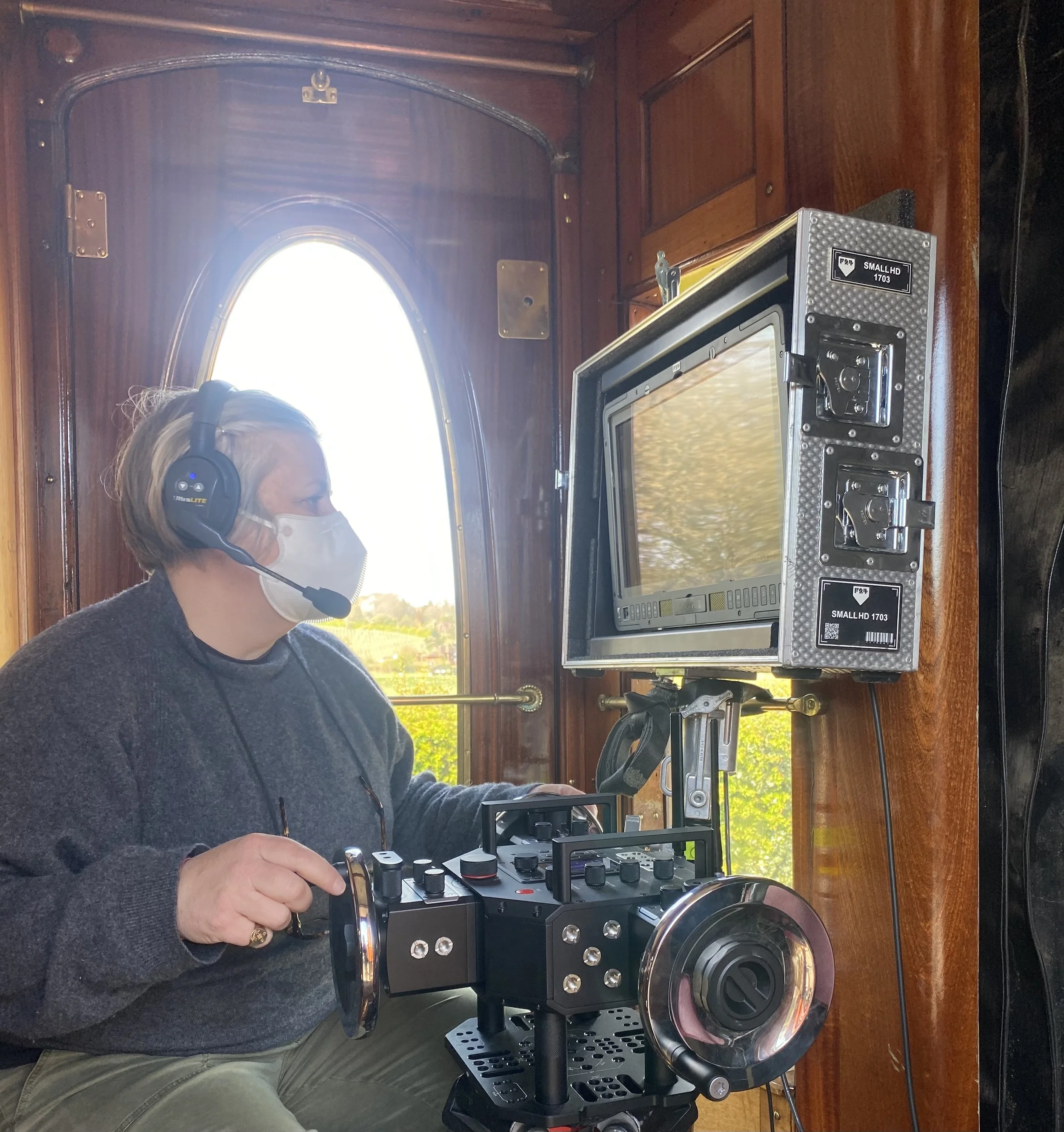 Operating B camera rigged on a moving steam train. Exterior shots out and over top of carriages.   Dailies "A very British Scandal"