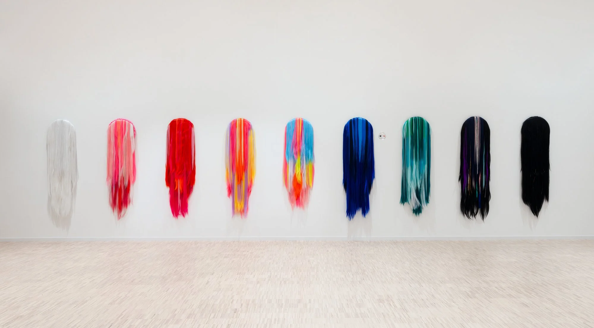 «5D Ambassadors I-IX» 2021-2025    
Acrylic hair on canvas and MDF
40 x 4 x 125 cm