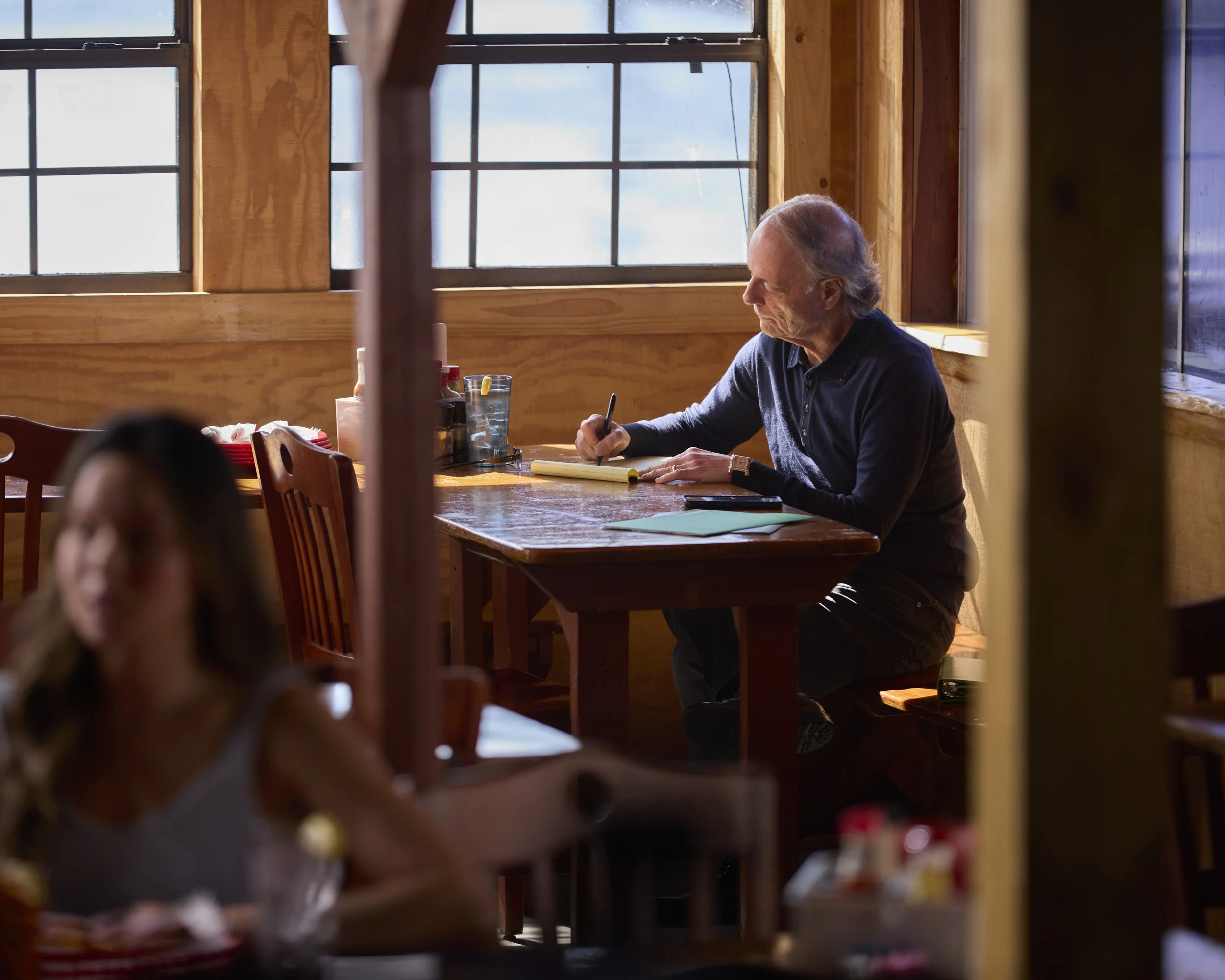 Documentary editorial photograph of attorney Eddie Farah working between meetings, created for a law firm brand storytelling campaign.