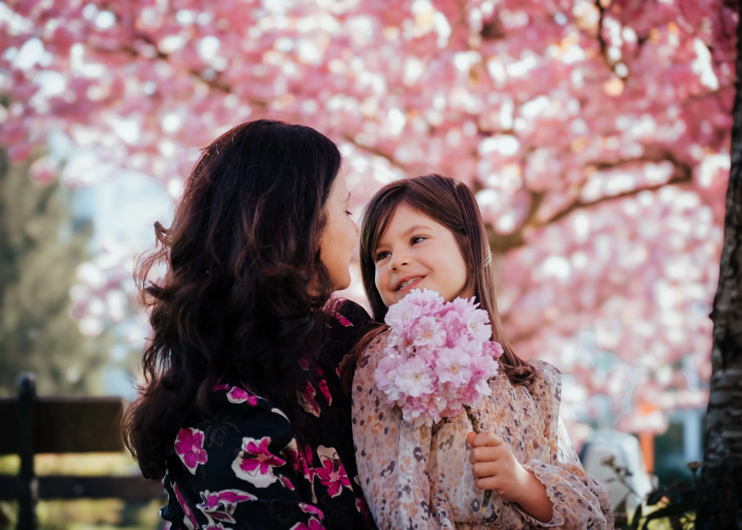 mother and daughter portrait under cherry blossoms