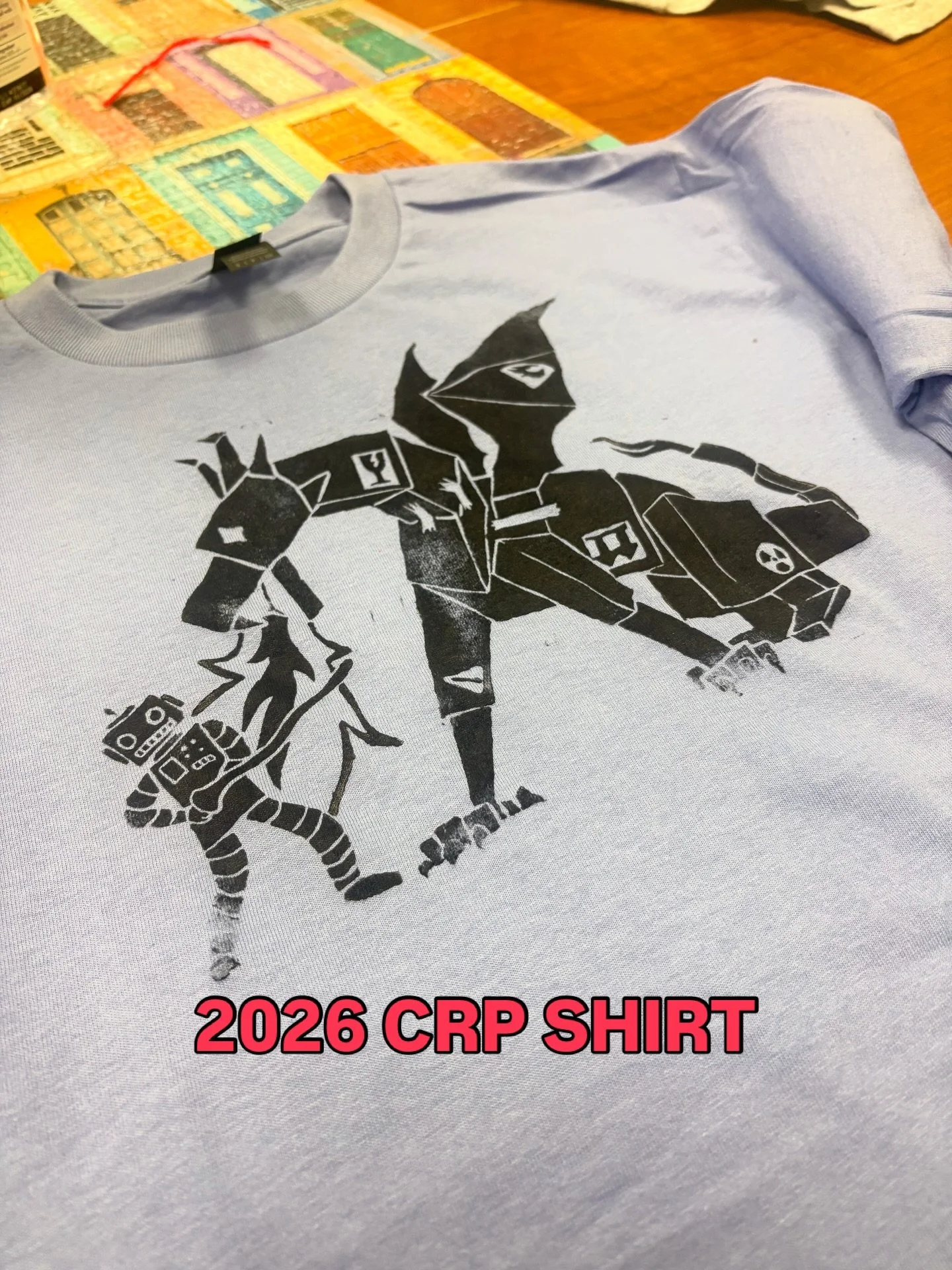 Check out our CRP 2026 shirt created and hand-printed by @j0hnny.ek!  Cardboard robot parade. 4.11.26.