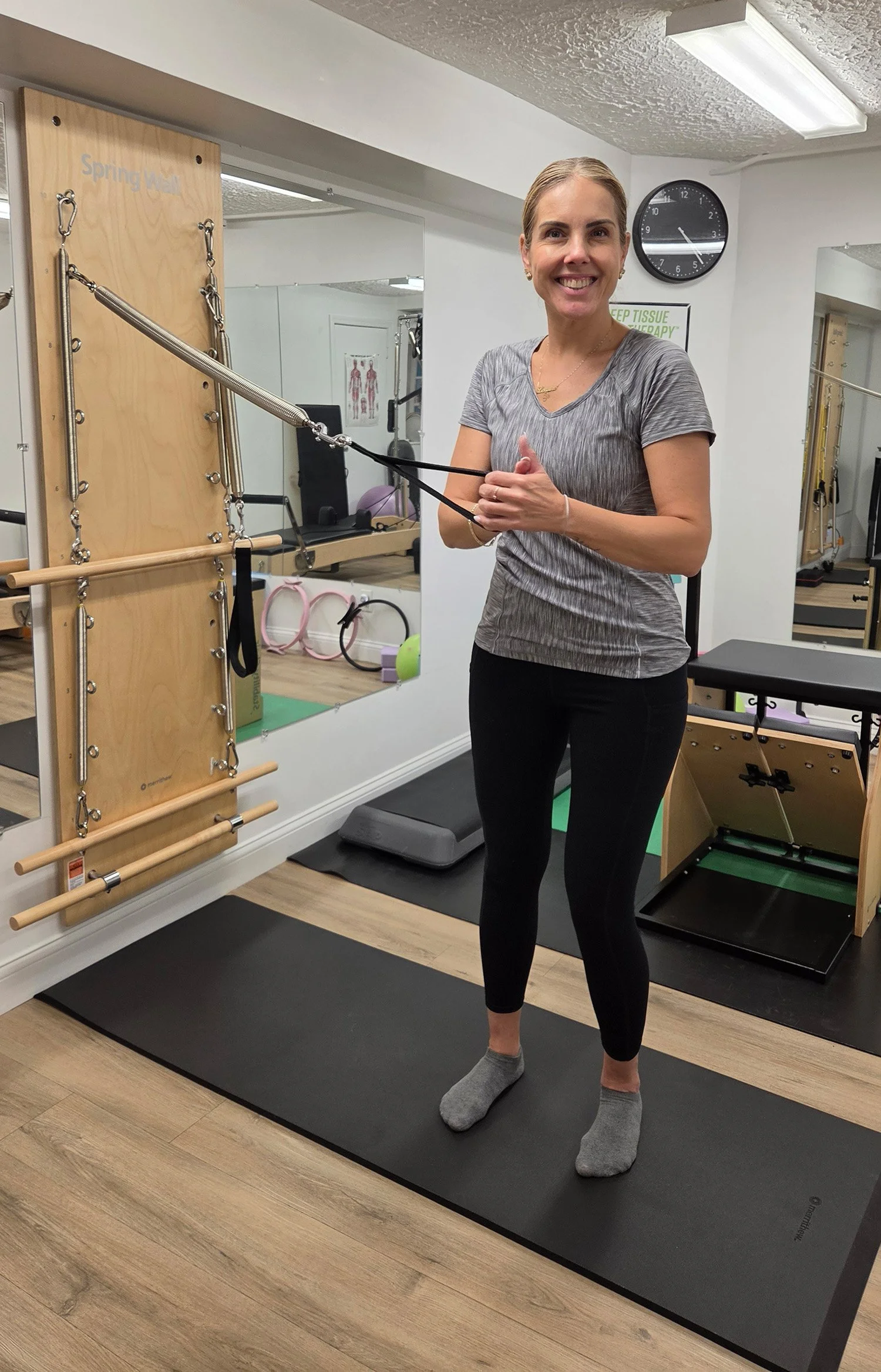 Lorraine, pilates instructor, in Newton MA, using a machine