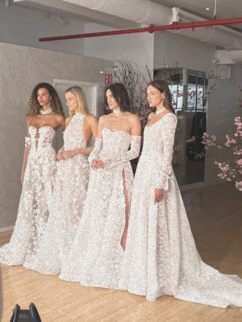 Four models posing in Berta Bridal wedding dresses.
