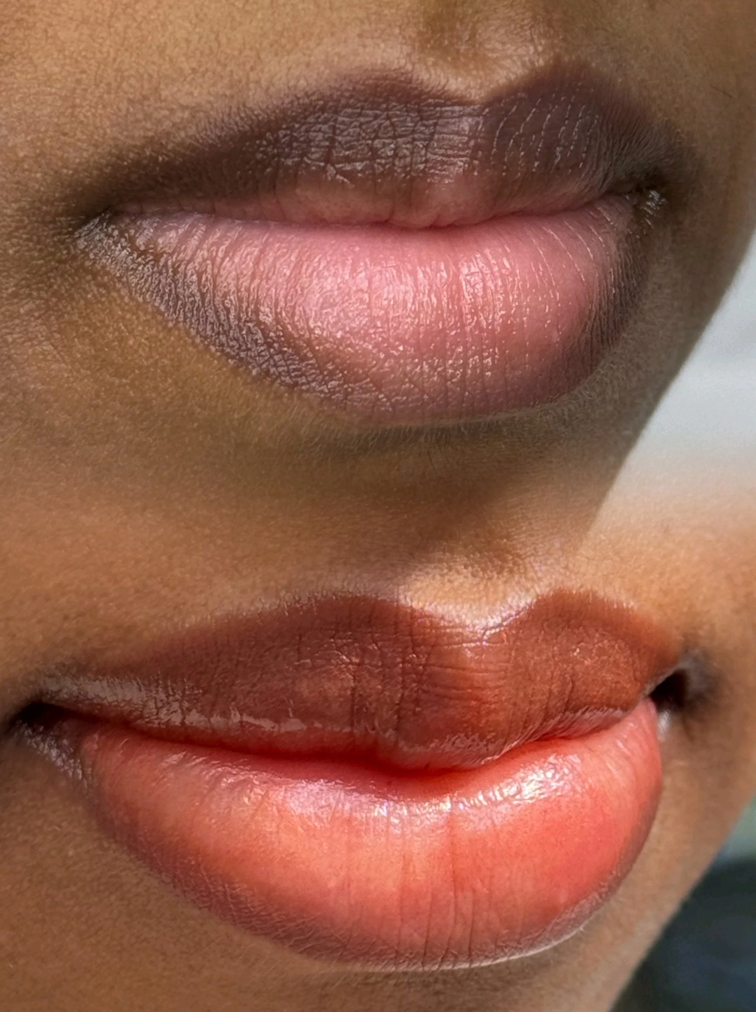 Close-up of two pairs of lips, one above the other, showing different shades.