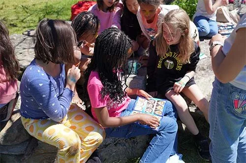 Group of campers reading a book