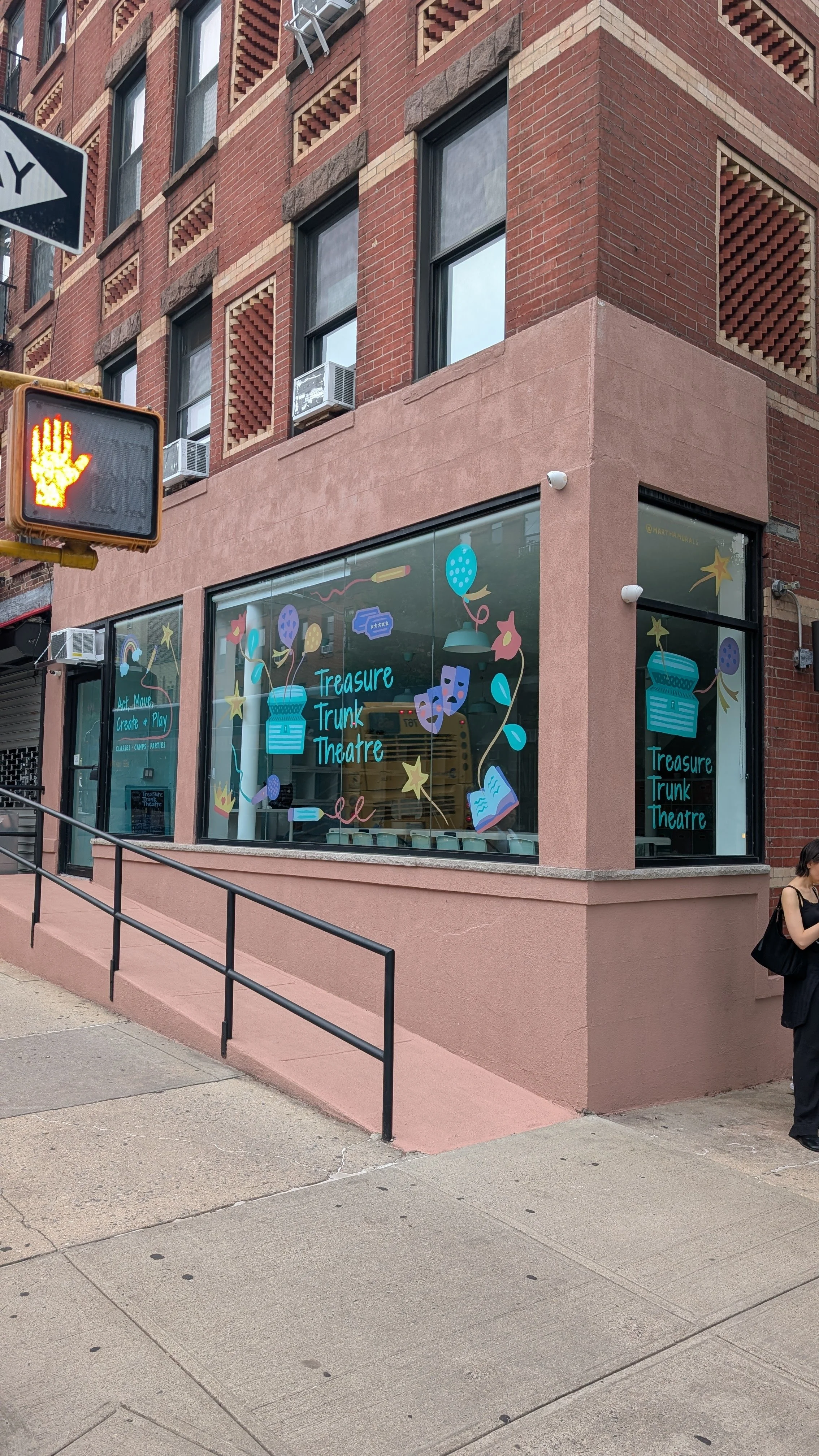 Hand-painting a window mural for Treasure Trunk Theatre in Park Slope