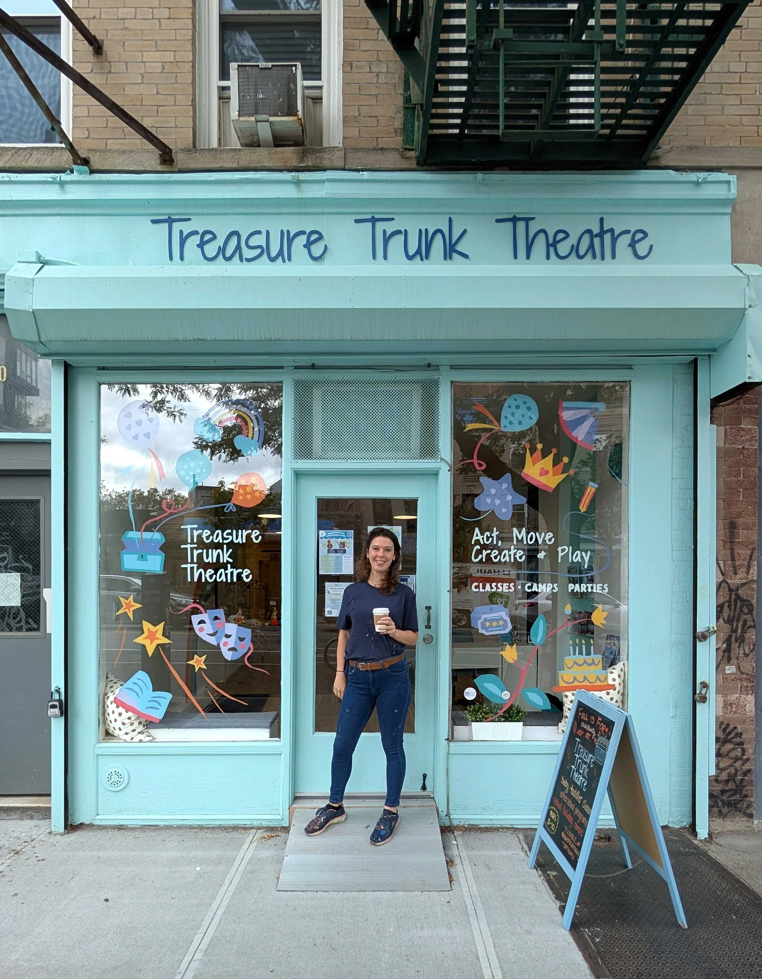 Brooklyn's Children's theatre window mural with Martha Antonelli standing in front