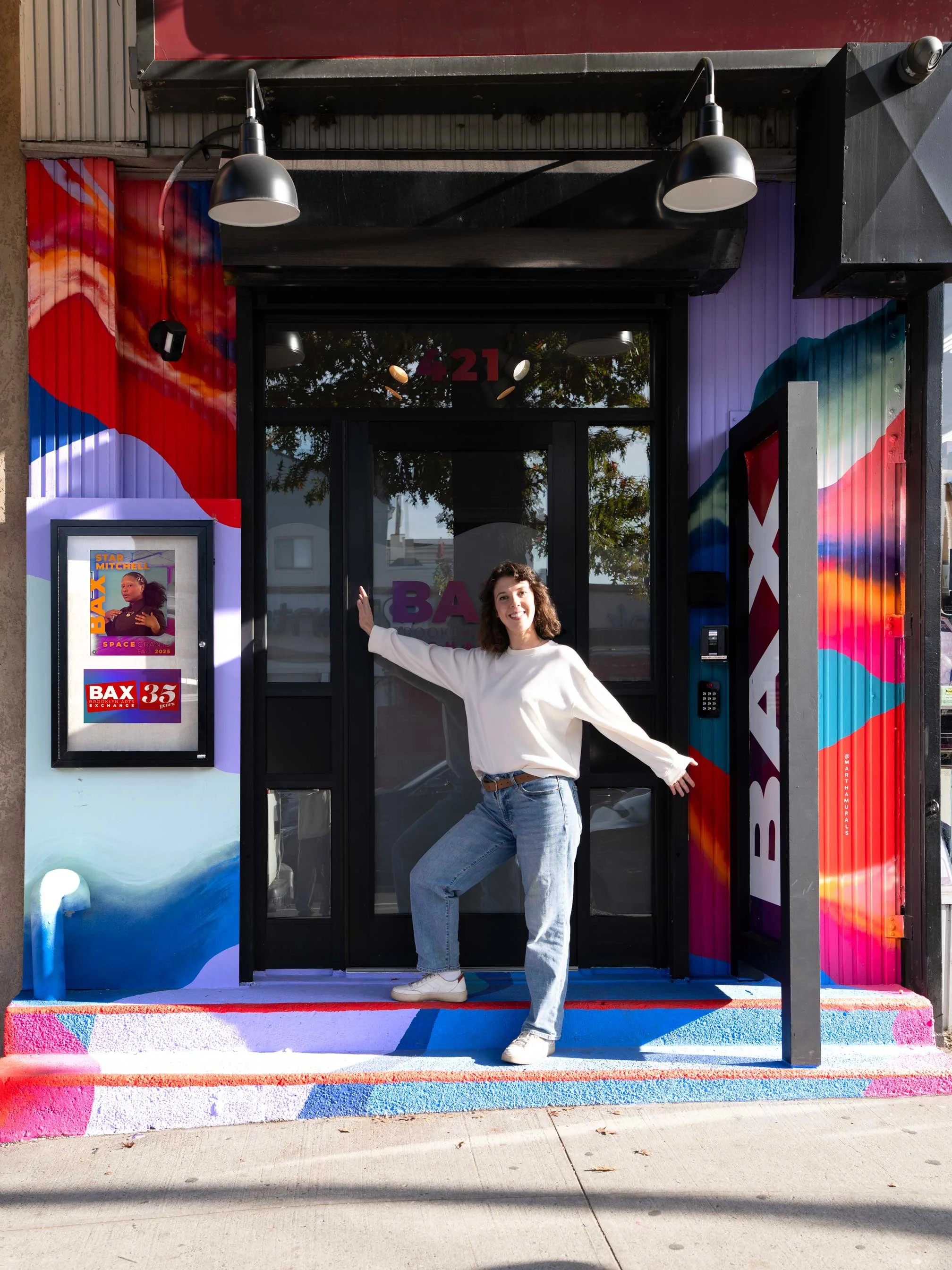 martha-antonelli-in-front-of-colourful-abstract-entrance-mural.jpg
