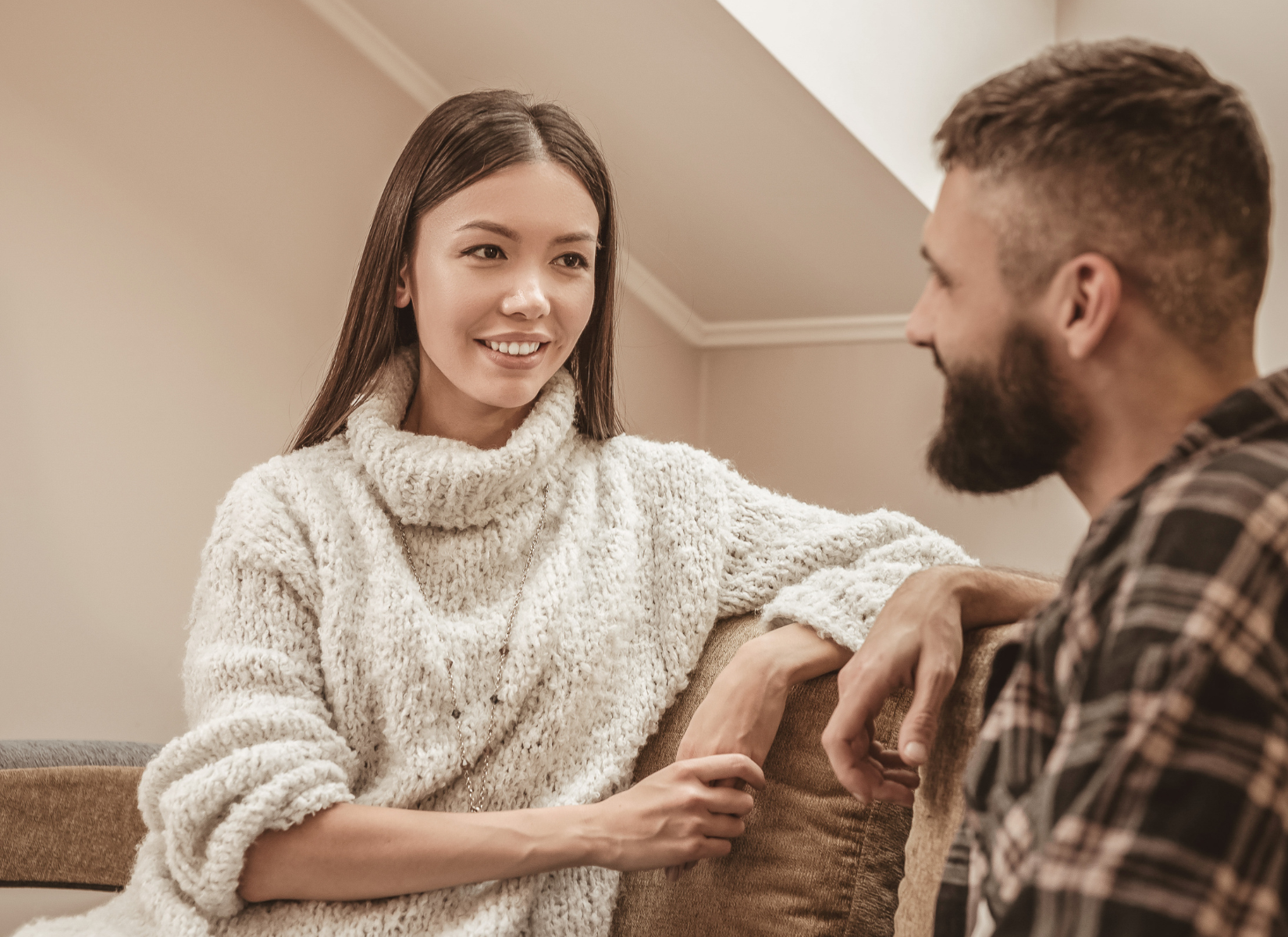 Couple sitting together and talking while facing each other