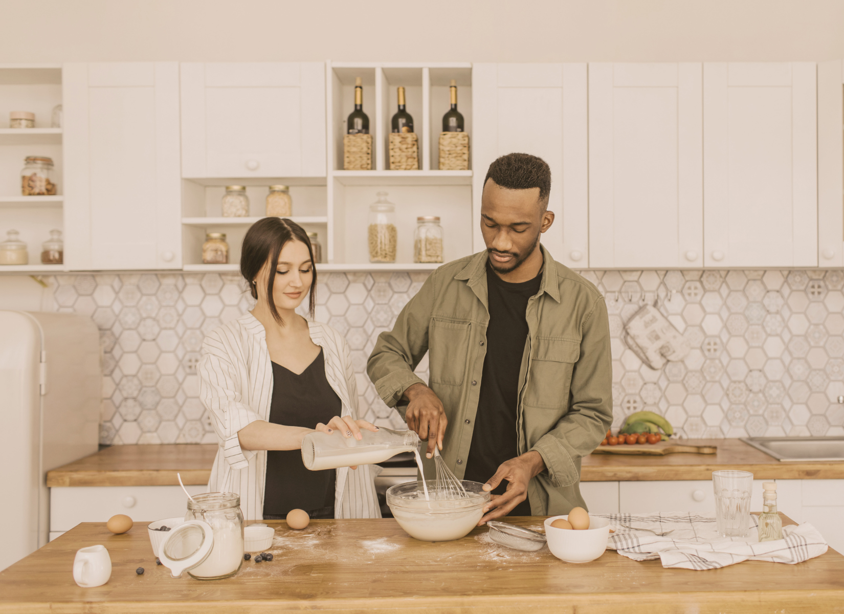 Couple working together to prepare food in a kitchen