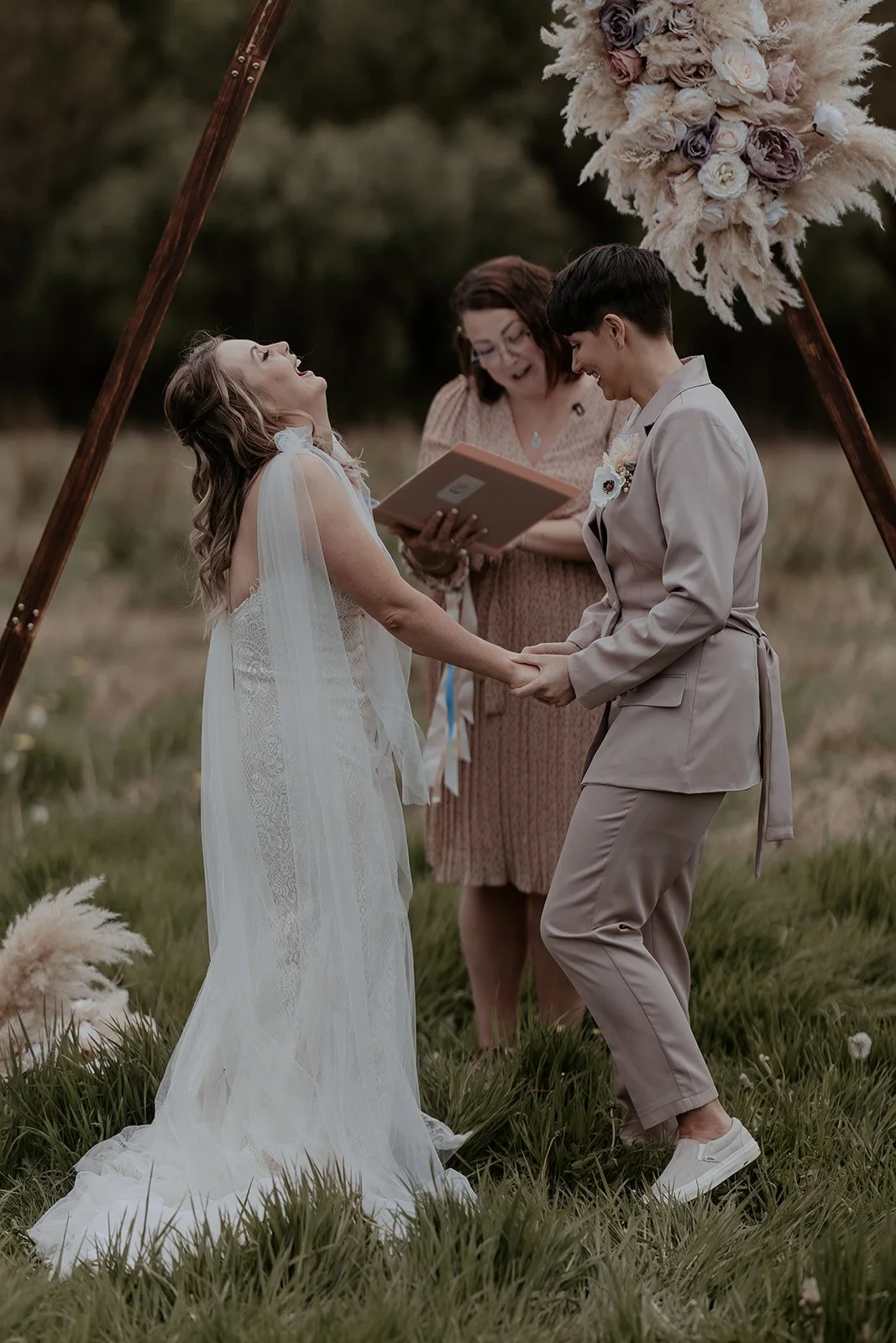 bride and bride laughing at outdoor dry hire wedding venue in Cumbria