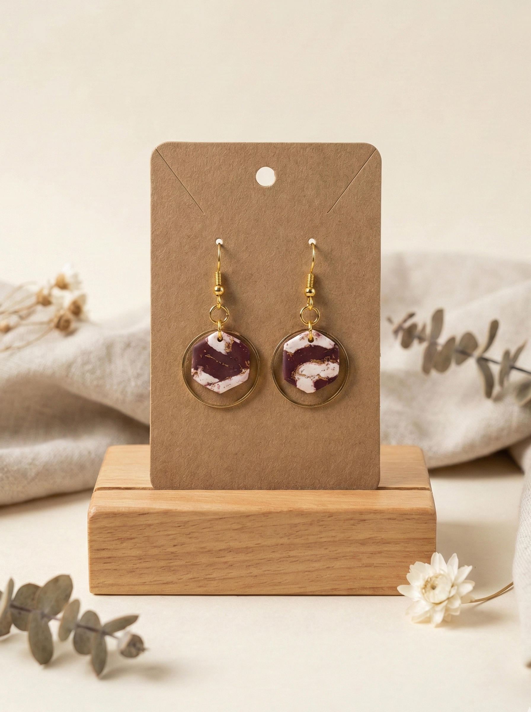 white and maroon marble with gold dangle mockup.png