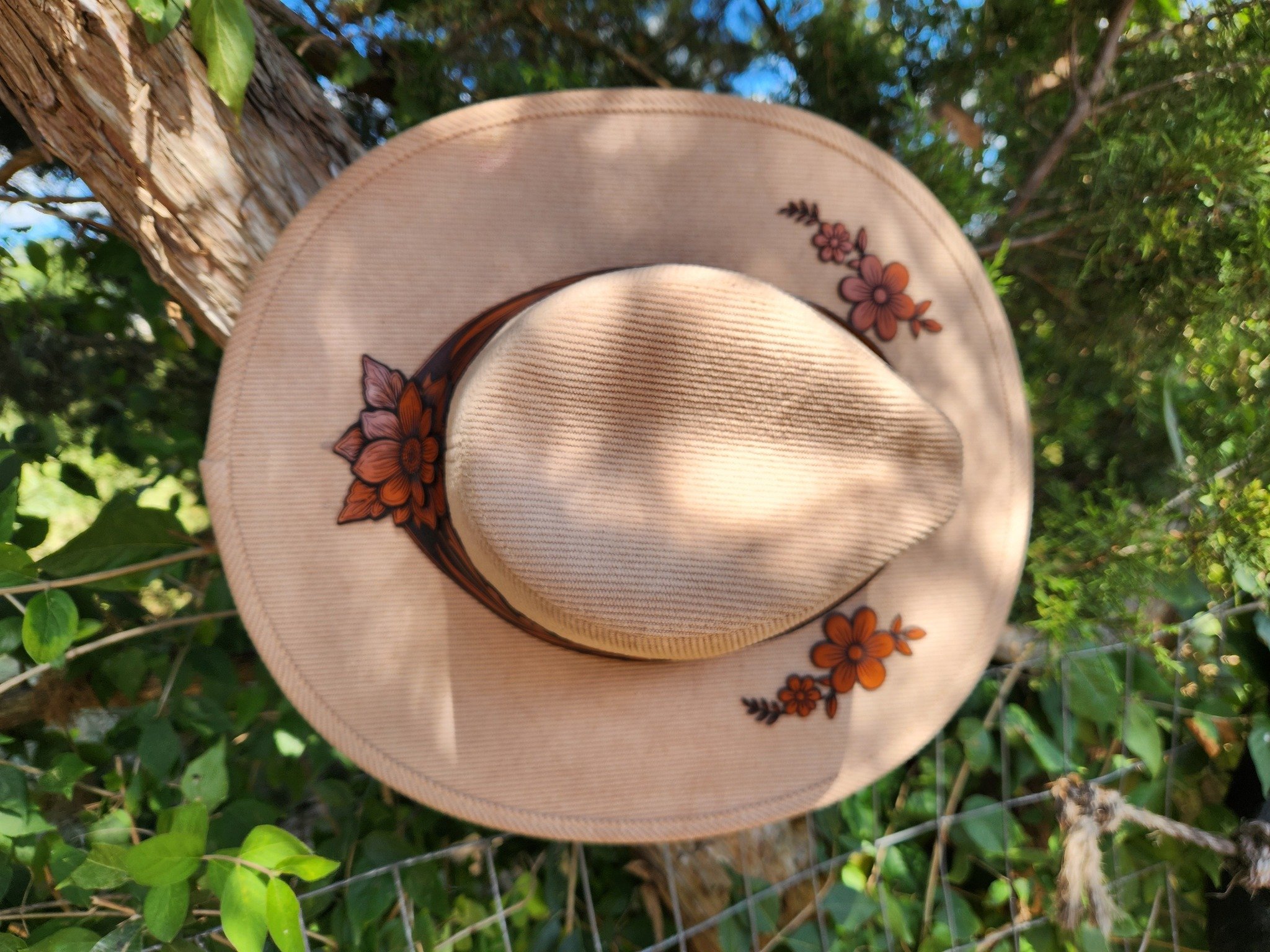 tan cowgirl with leather flowers top view.jpg