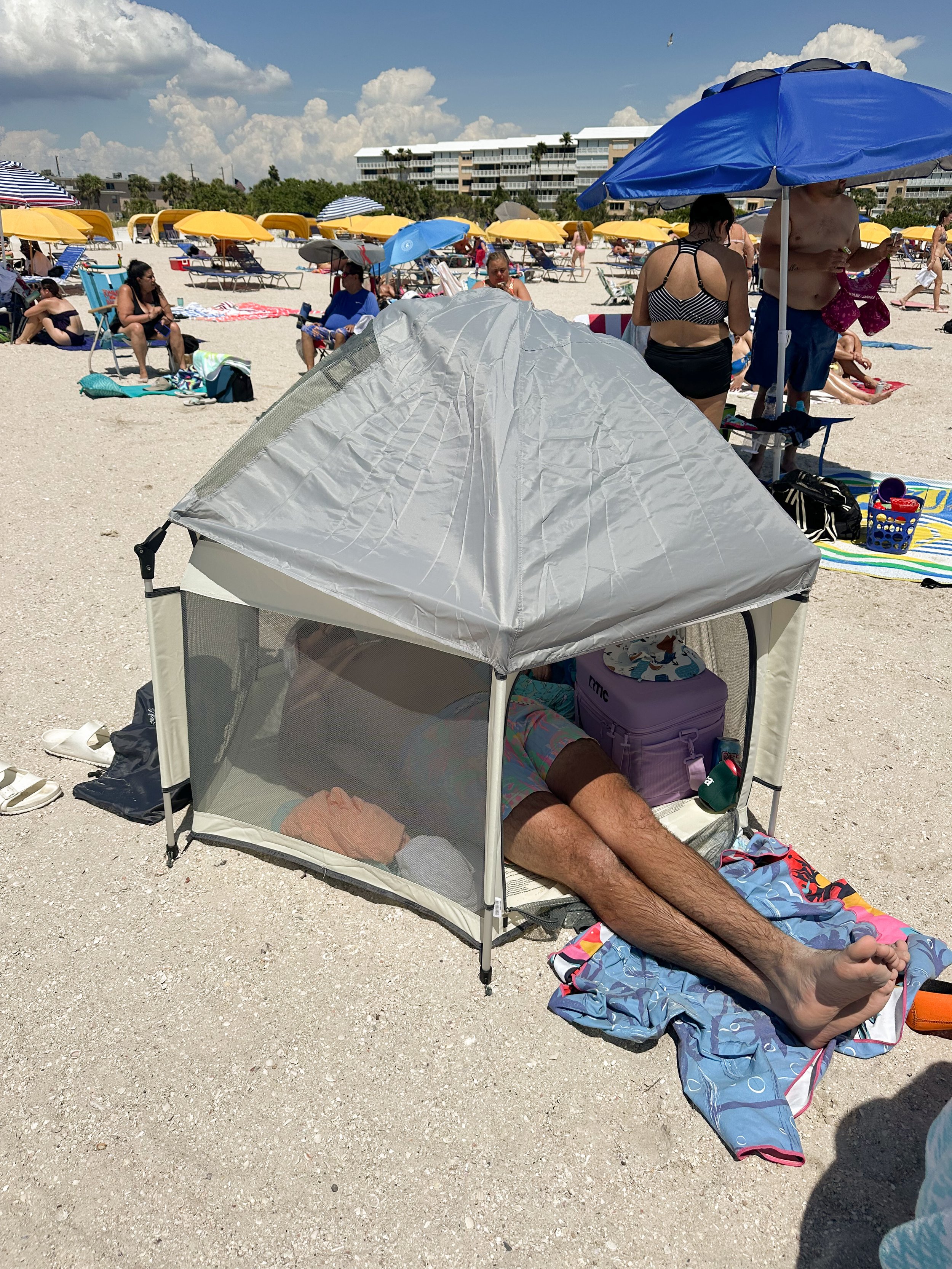 Pop-up beach tent providing shade for a baby napping at the beach