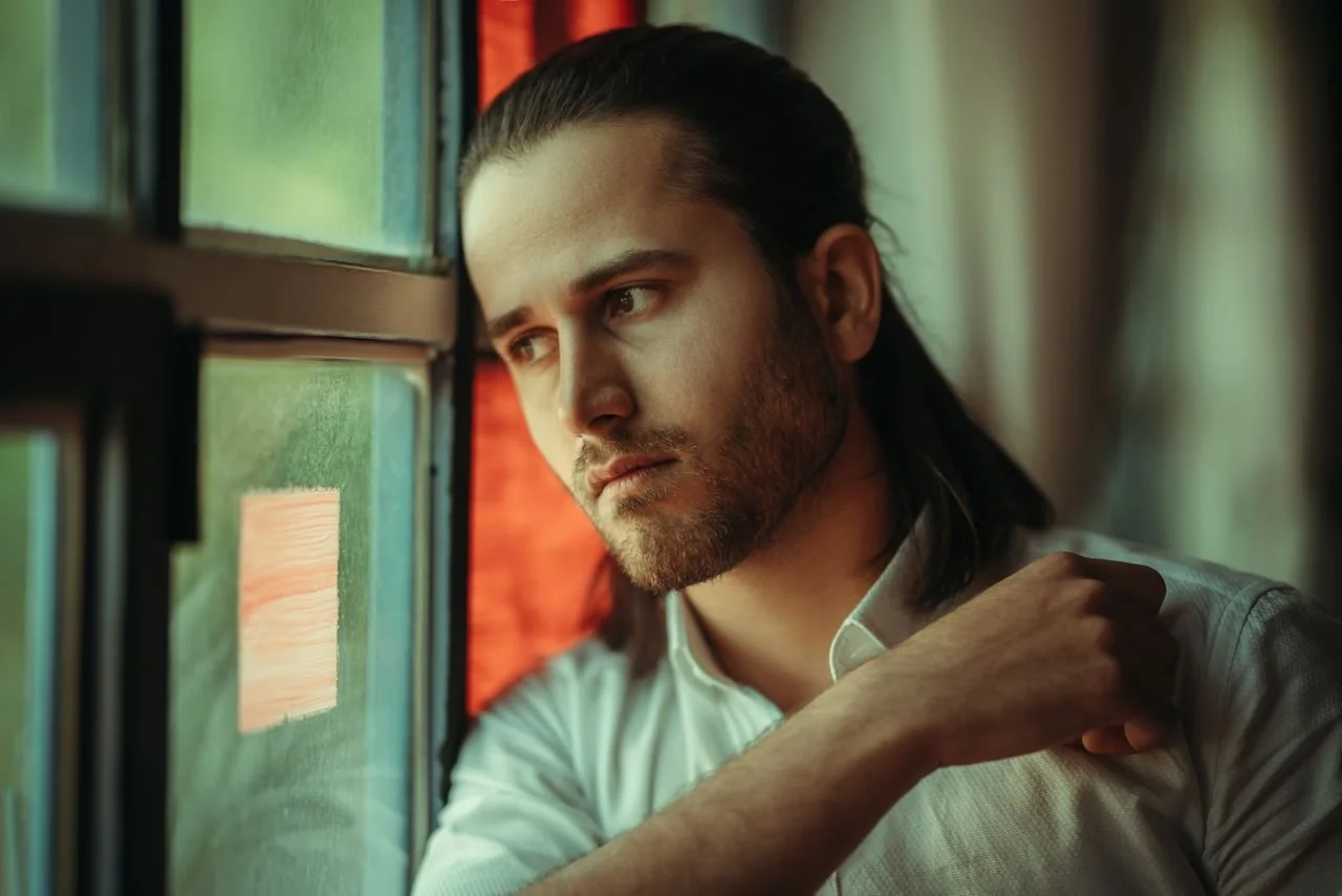 man-in-shirt-by-window
