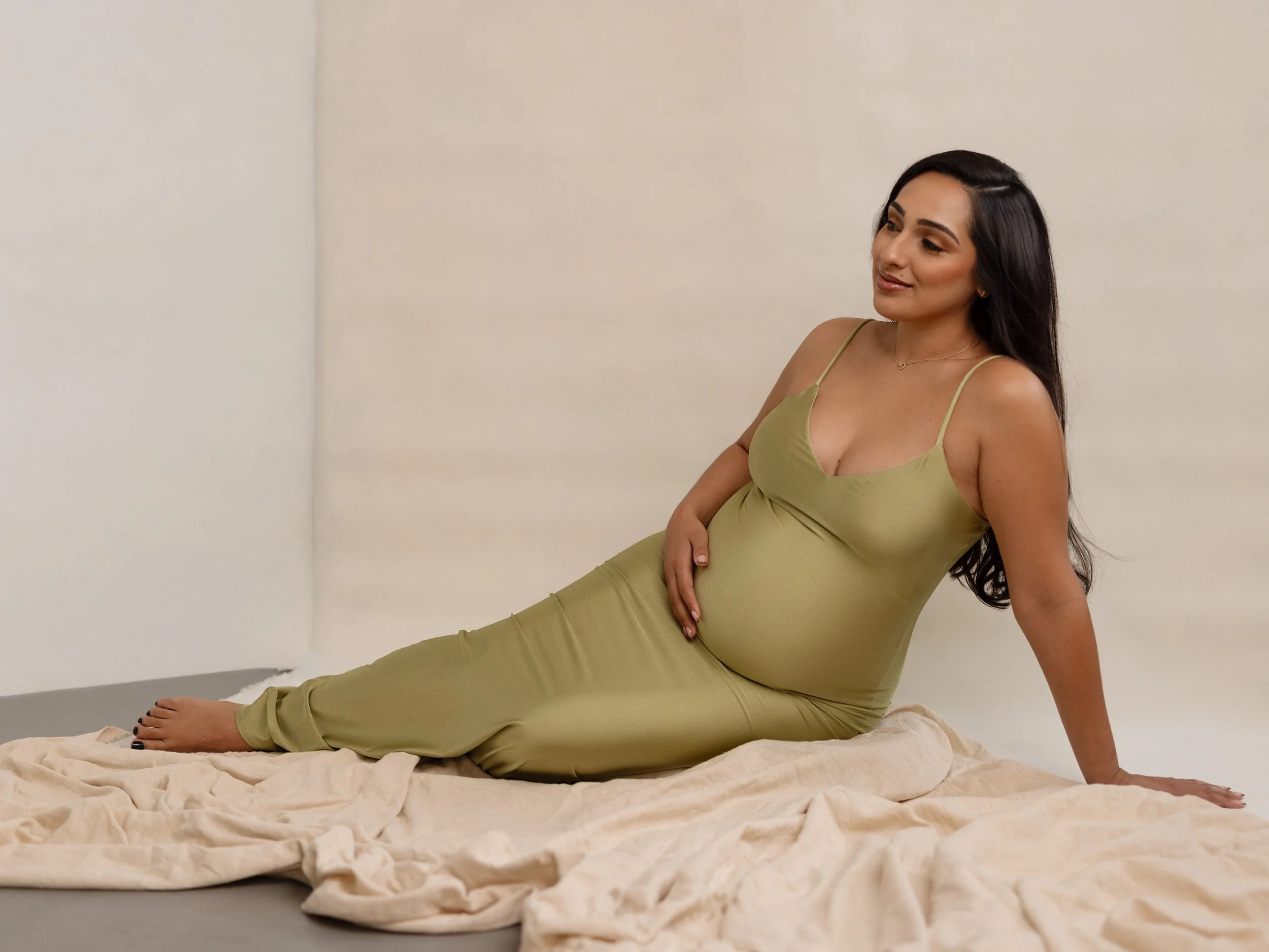 Linda during maternity session with Ericka holding her baby bump during a portrait session with Ericka B. Photography in Los Angeles