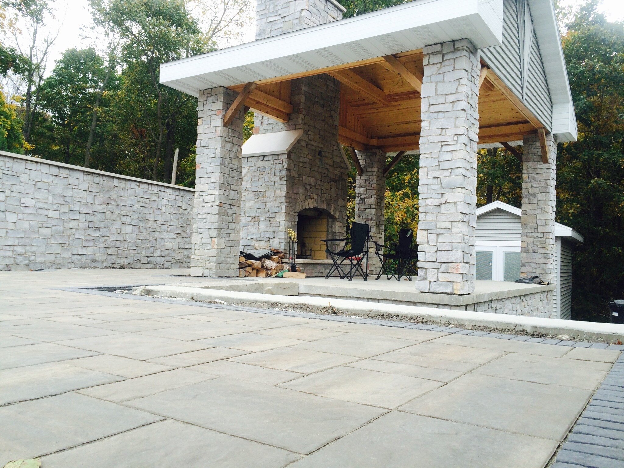 Feeling the warmth of tradition and the grandeur of nature in this stunning scene. Our gathering place, nestled under towering pillars and a majestic pavilion, invites stories to be shared and memories to be made