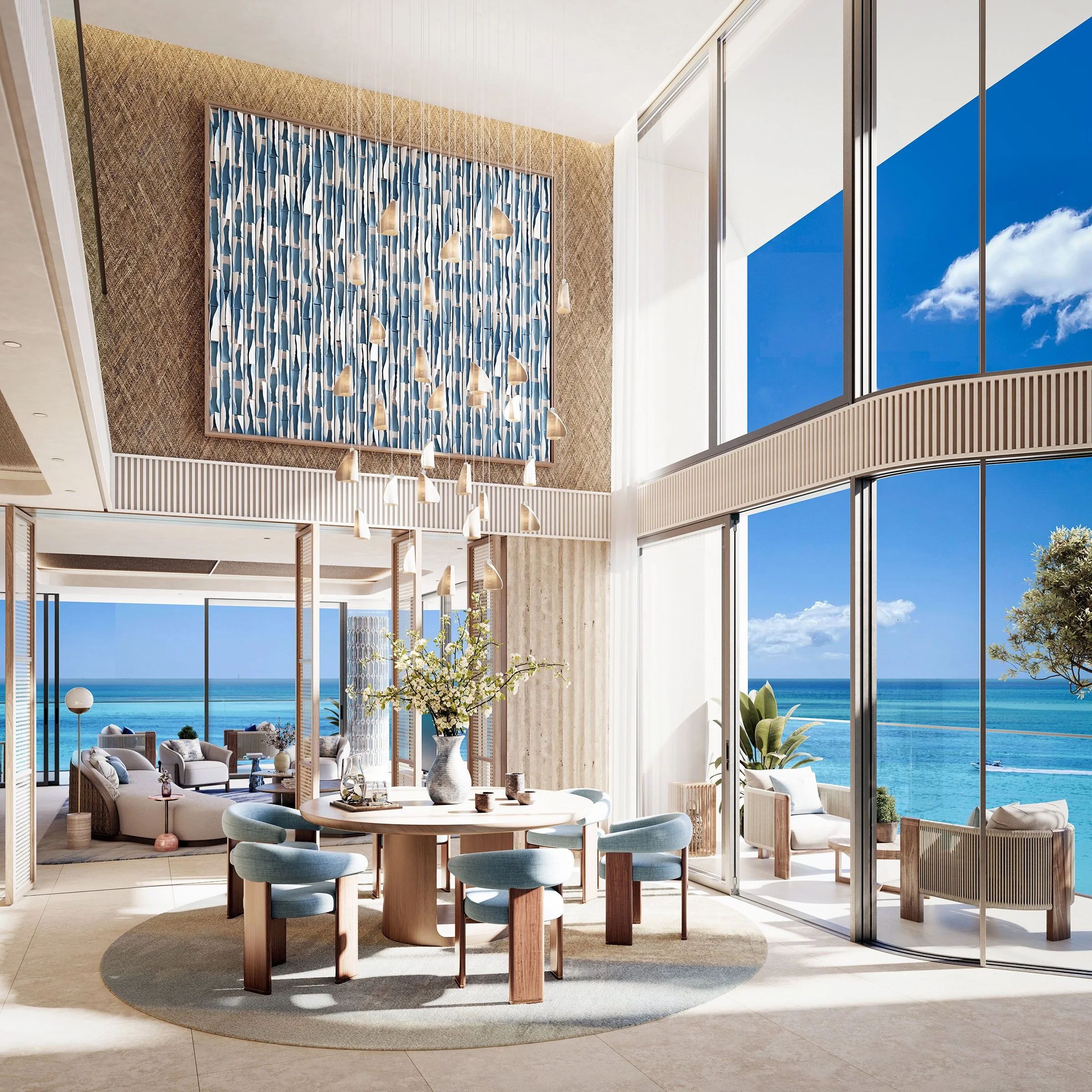 Modern interior living space with large windows overlooking the ocean, featuring a round wooden dining table with light blue chairs, a beige rug, and decorative plants.