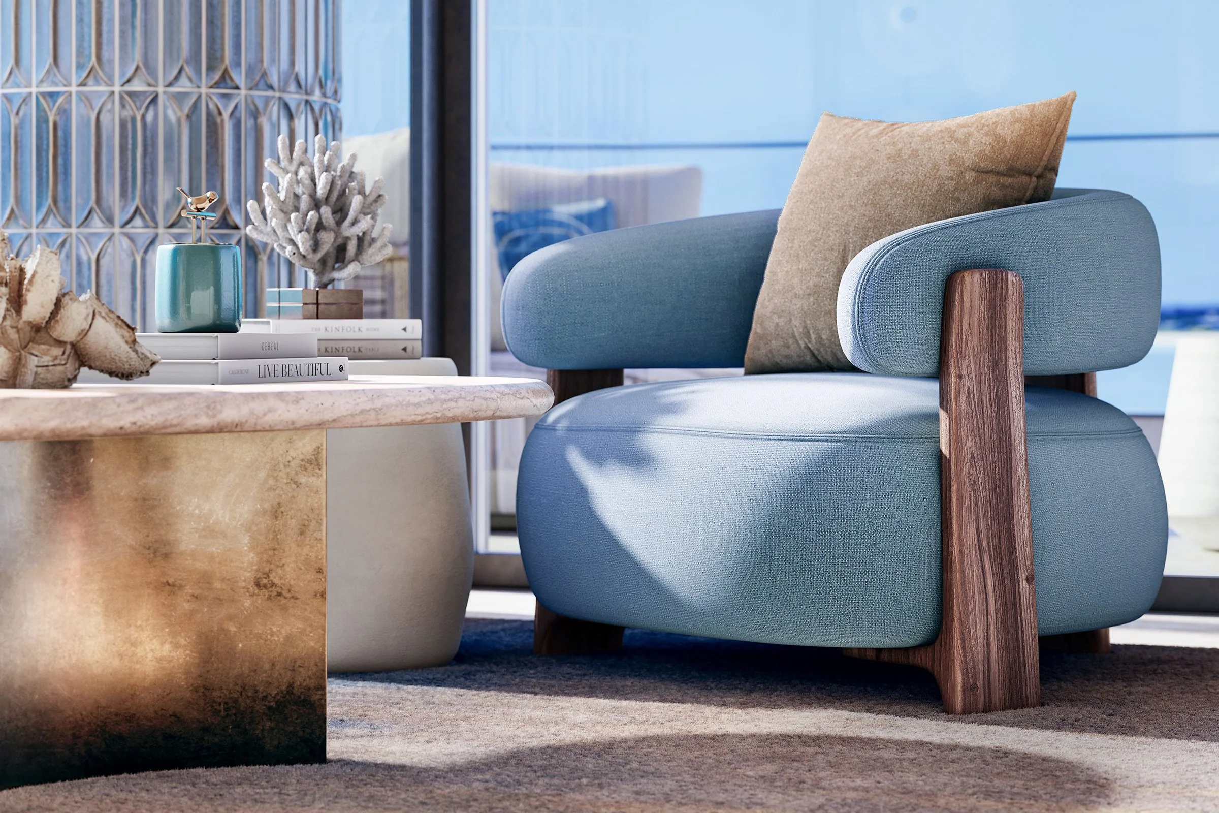 A modern living room with a blue armchair featuring wooden armrests and a beige pillow. A beige marble coffee table holds a small turquoise vase with a decorative plant, books, and natural wood accents. The background includes a textured glass wall with a hint of blue sky outside.