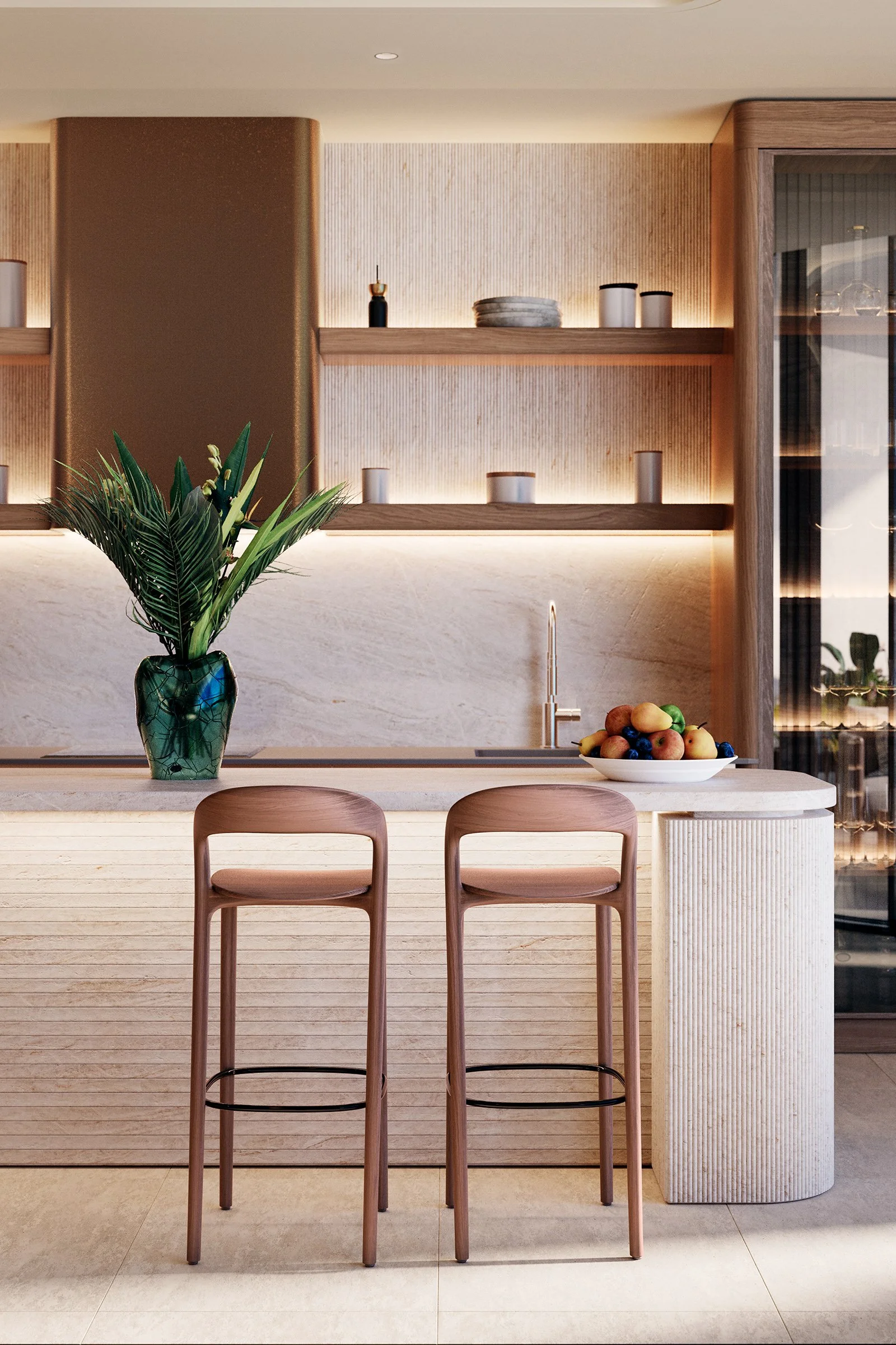 A modern kitchen with a white marble island, pink bar stools, a green vase with plants on the counter, a bowl of assorted fruit, and wooden shelves with decorative items and illuminated backlighting.