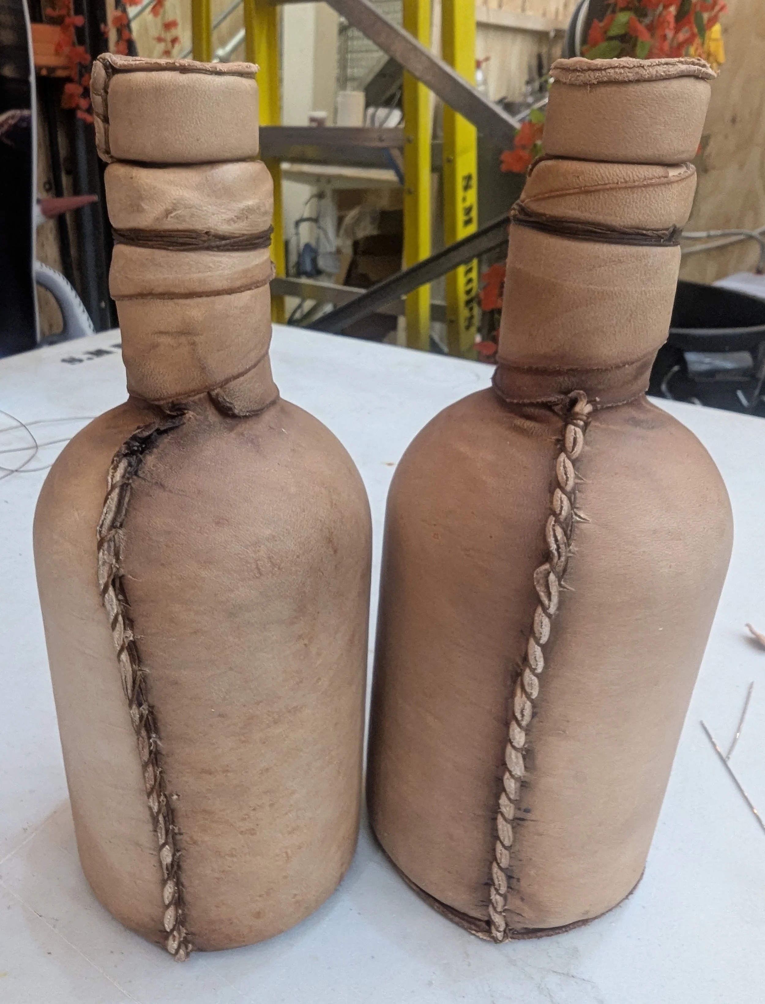 Alan Brooker Drapes, moulded leather bottles 