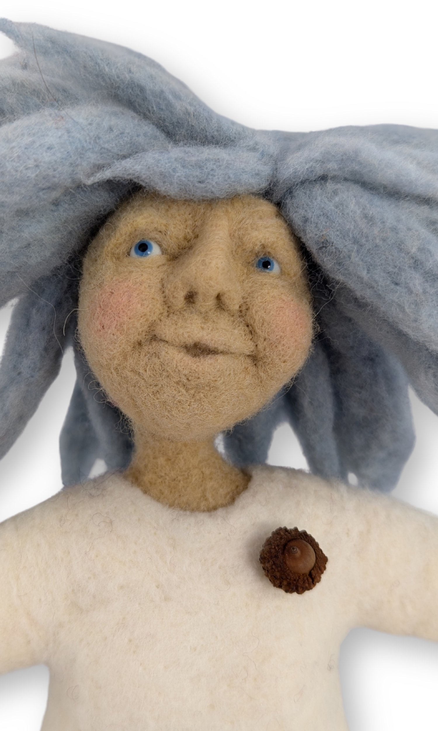 Detailed view of the doll’s face showing felted features and expressive blue hair.