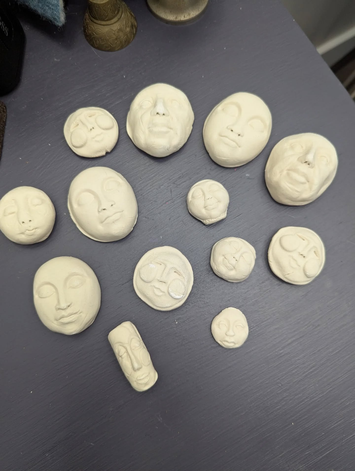 I made a few little starter faces for this weekend's spirit doll Workshop.

I love this part of the class because people usually come in saying, "I can't make a face!" But then... they take these little bits and add more clay and more, well