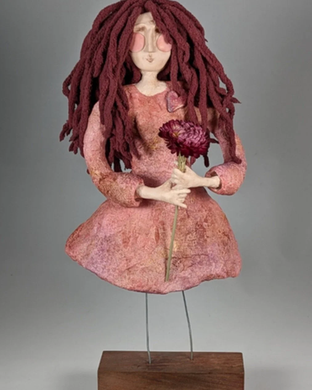 People sometimes expect spirit dolls to look otherworldly.

But look at her. She&rsquo;s just a woman holding a flower. A little wild-haired, a little pink-cheeked, completely herself.

That&rsquo;s the thing about these figures&mdash;the spirit isn&
