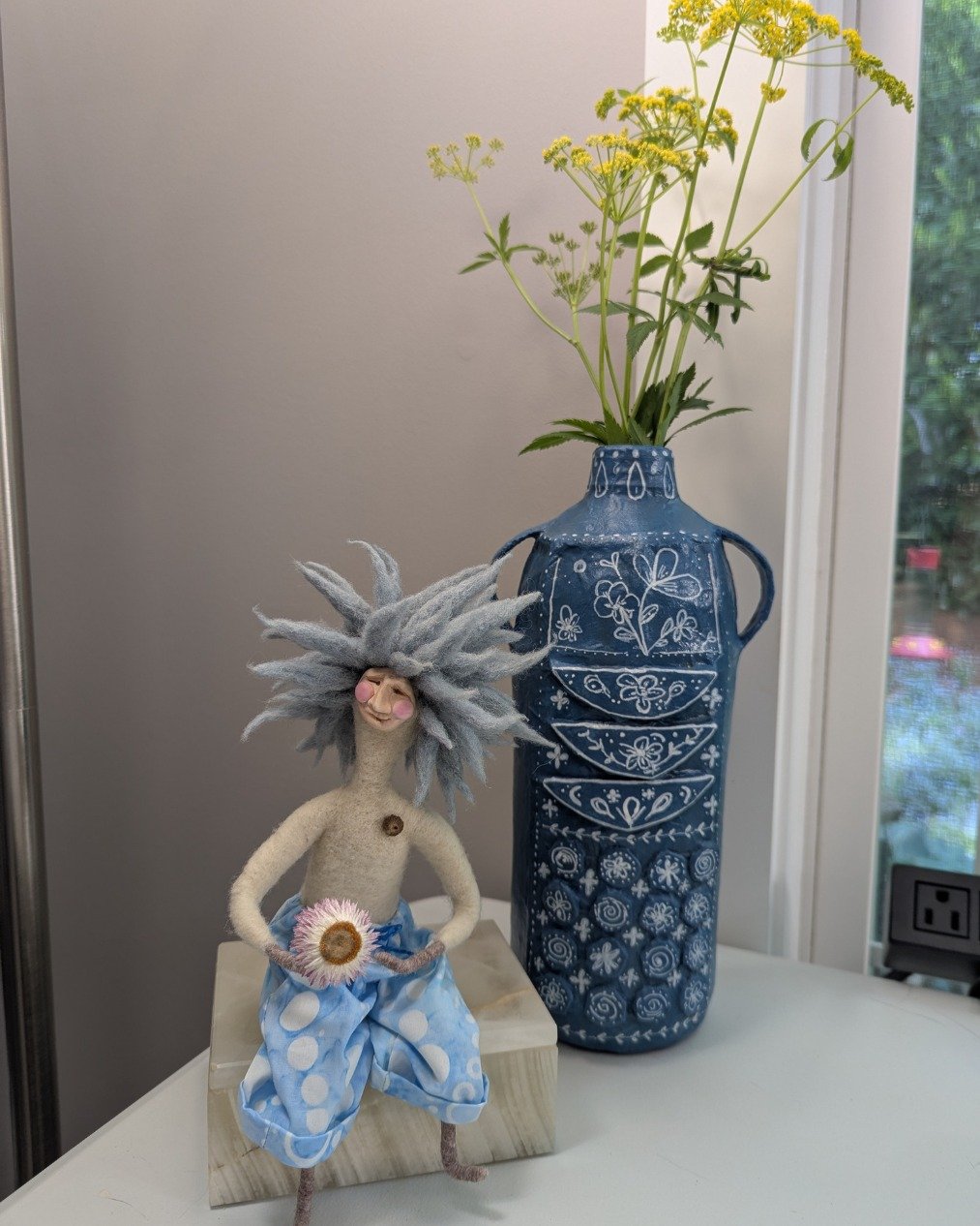 The view from my desk...

The vase? My new favorite thing I've made. It's this month's Artful Crone project, because May is for pretty things. And it's even more special when you get to say, I made that!

And Surfer Dude? He's there to remind me to s