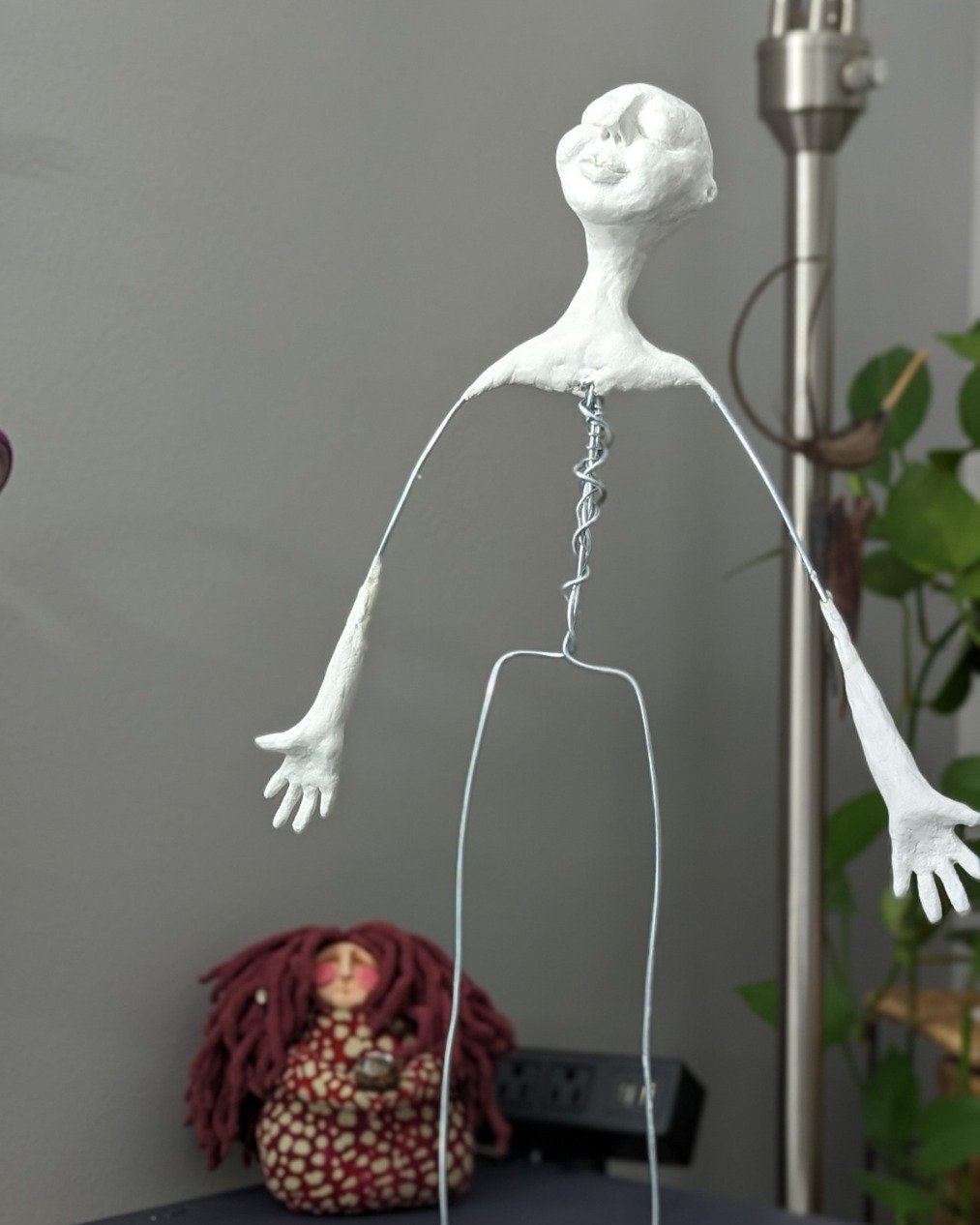 She doesn't have her colors yet. No hair, no clothing, no story &mdash; just wire and clay and arms wide open.

But she already has something. You can feel it even at this stage.

That's the thing nobody tells you about making spirit dolls. The momen
