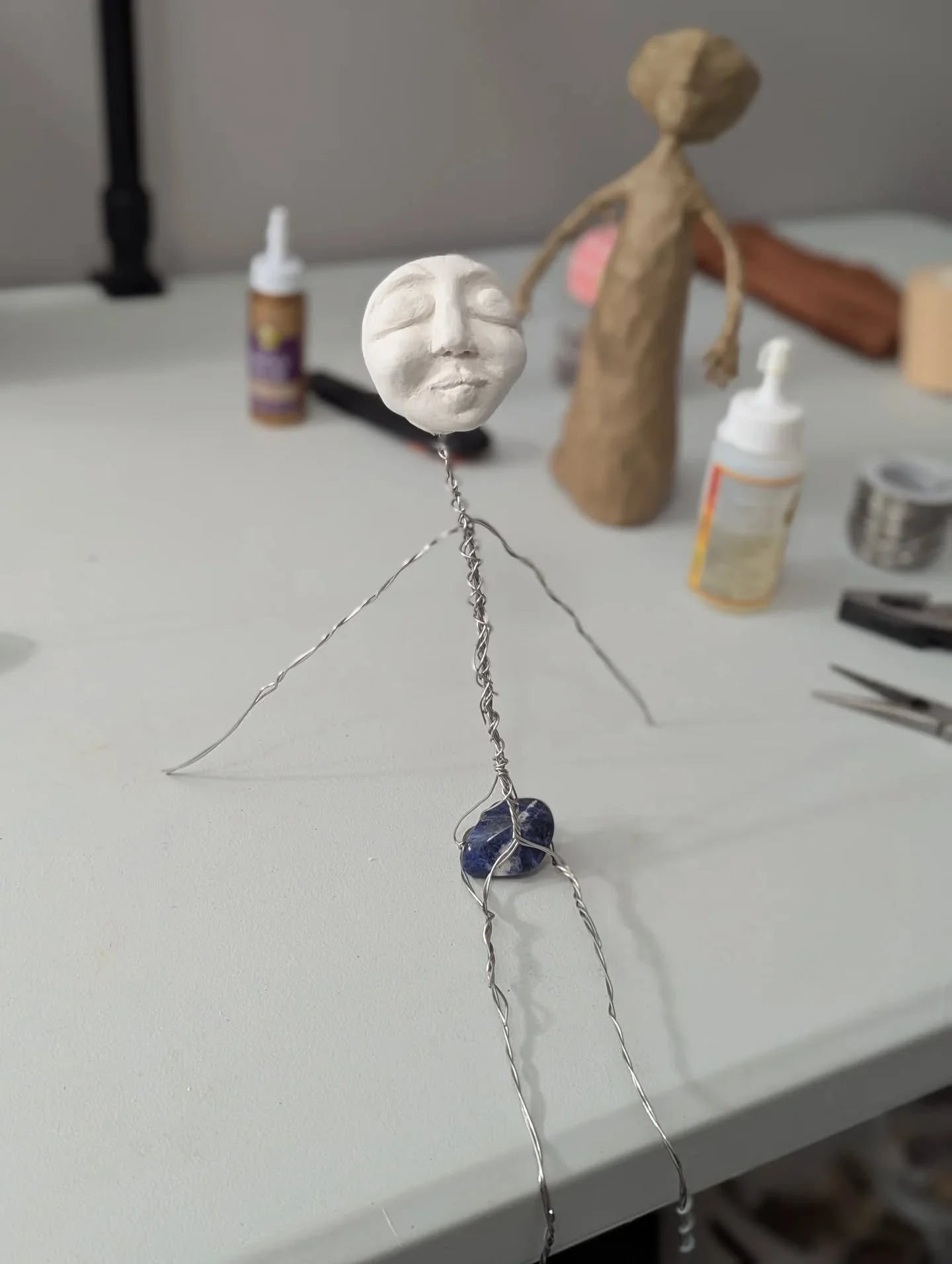 The making of a Spirit Doll. Here's what's on my work table this morning...

This little doll had a body. Hands feet all of it, but it wasn't quite right. Parts of her were too small and I was trying to disguise that by making other parts even smalle