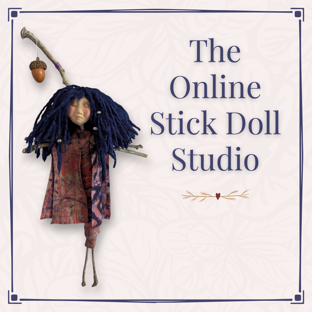 Handmade stick doll with dark blue yarn hair, patterned clothing, twig arms, and a hanging acorn in The Online Stick Doll Studio graphic.