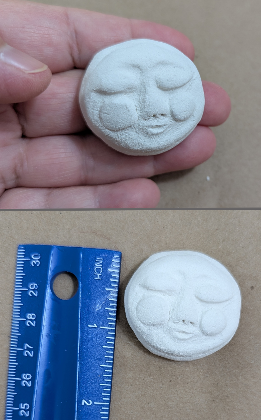 Two-photo image of a small round handmade paper-clay starter face with full cheeks, shown held in hand above and beside a ruler below for size reference.