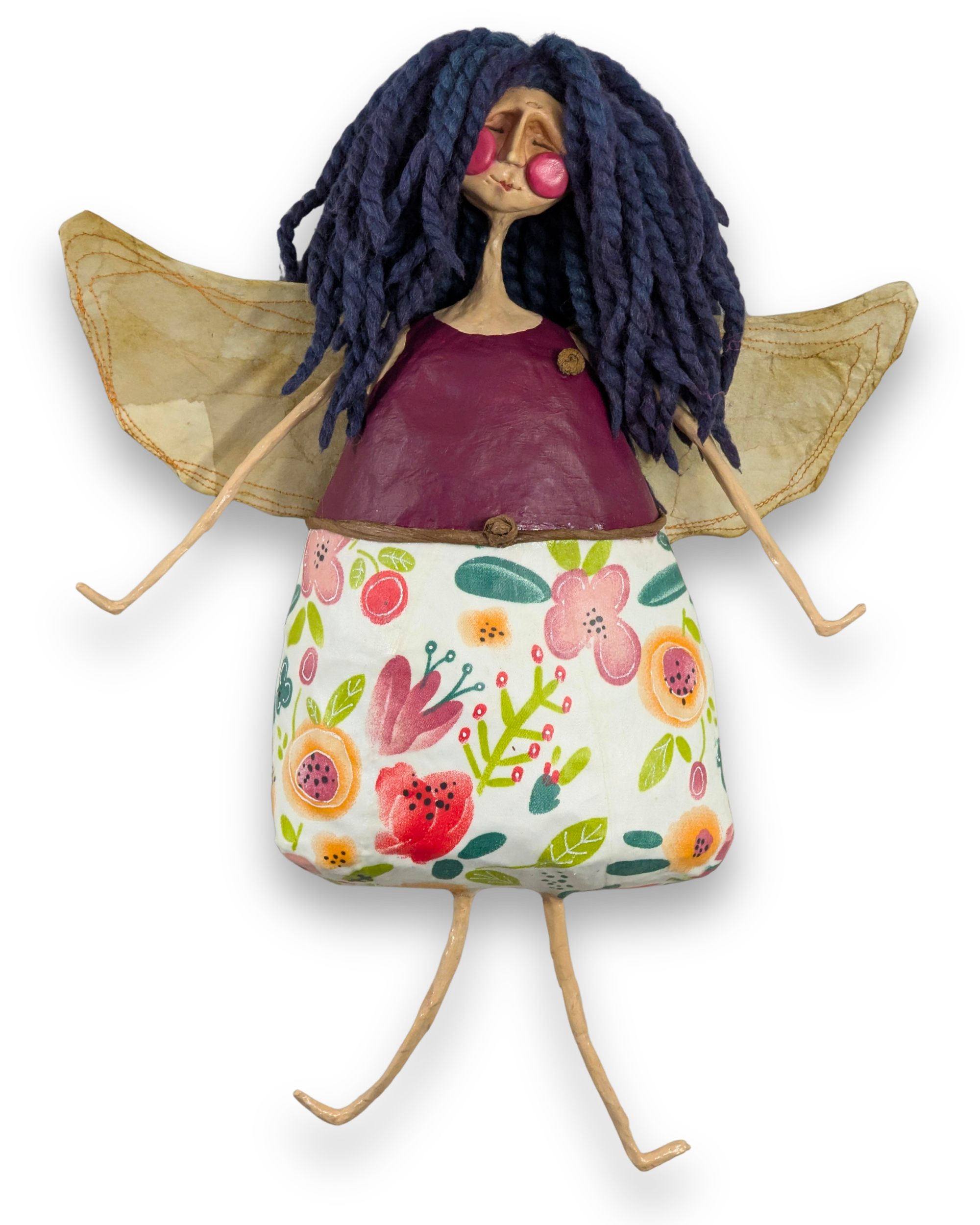 Sally Ann, a handmade papier-mâché angel with dark blue hair, a burgundy bodice, colorful floral skirt and golden wings.