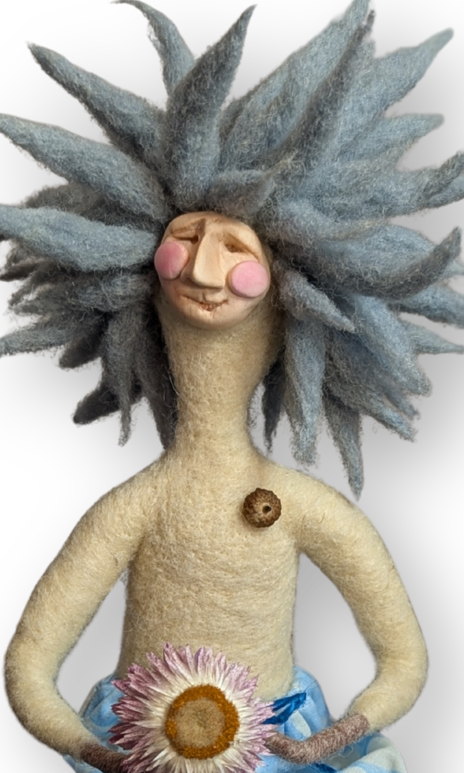 Close-up of Surfer Dude Guardian Doll’s smiling face, showing handmade clay details and blue wool hair.