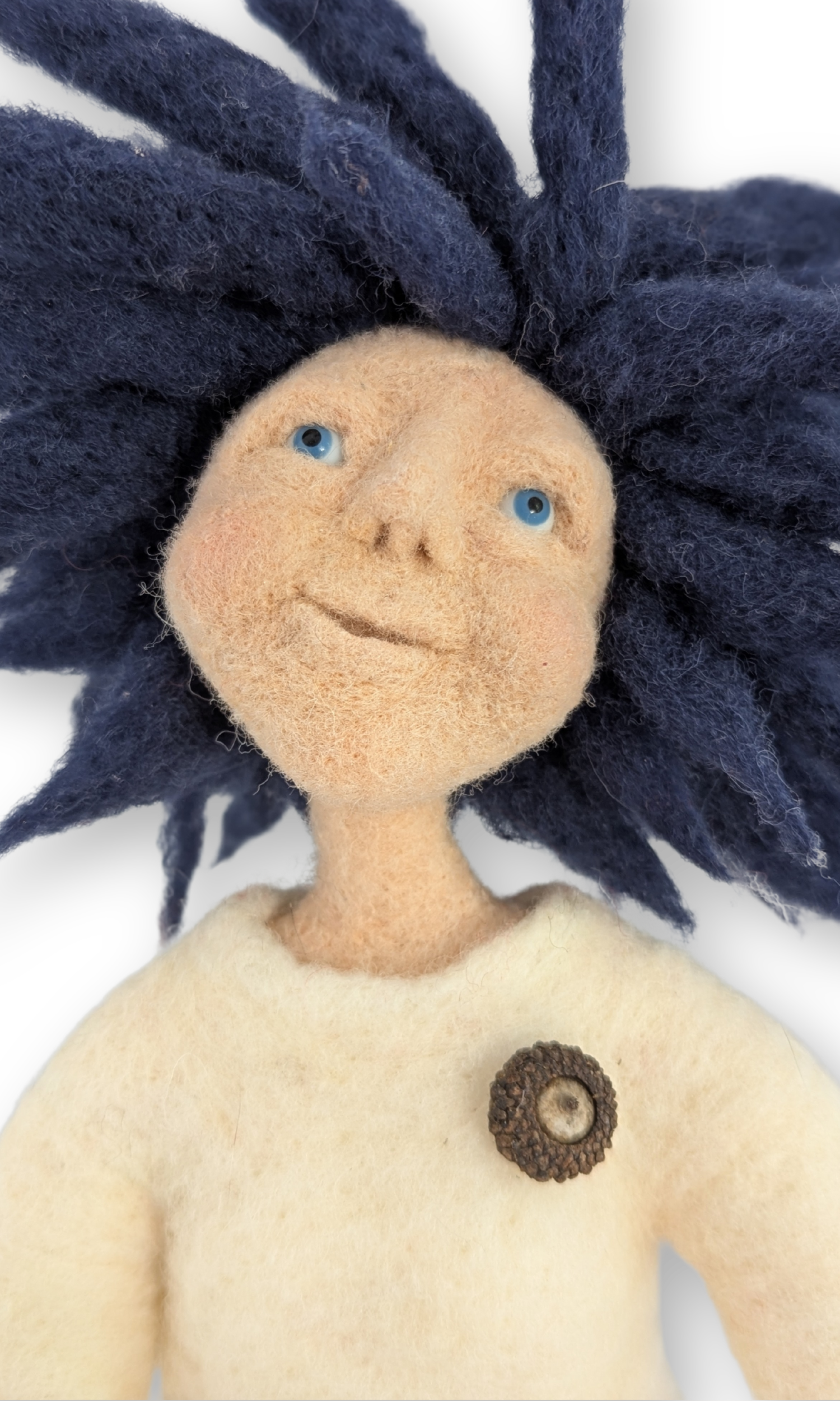 Close-up of Dreamer Guardian Doll’s face with blue eyes and a serene, upward gaze.