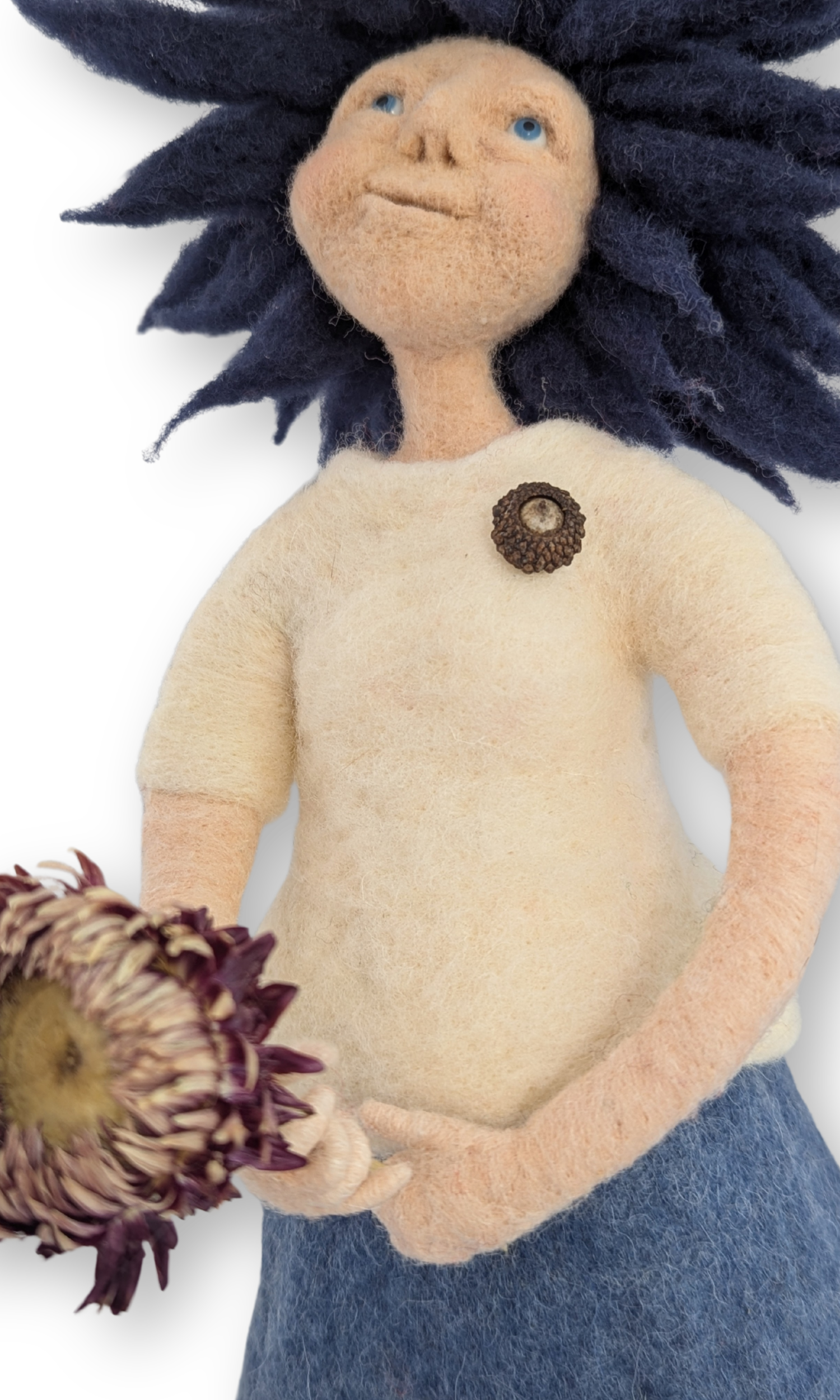Close-up of Dreamer Guardian Doll’s hands holding a dried flower, highlighting needle-felted textures and acorn heart detail.