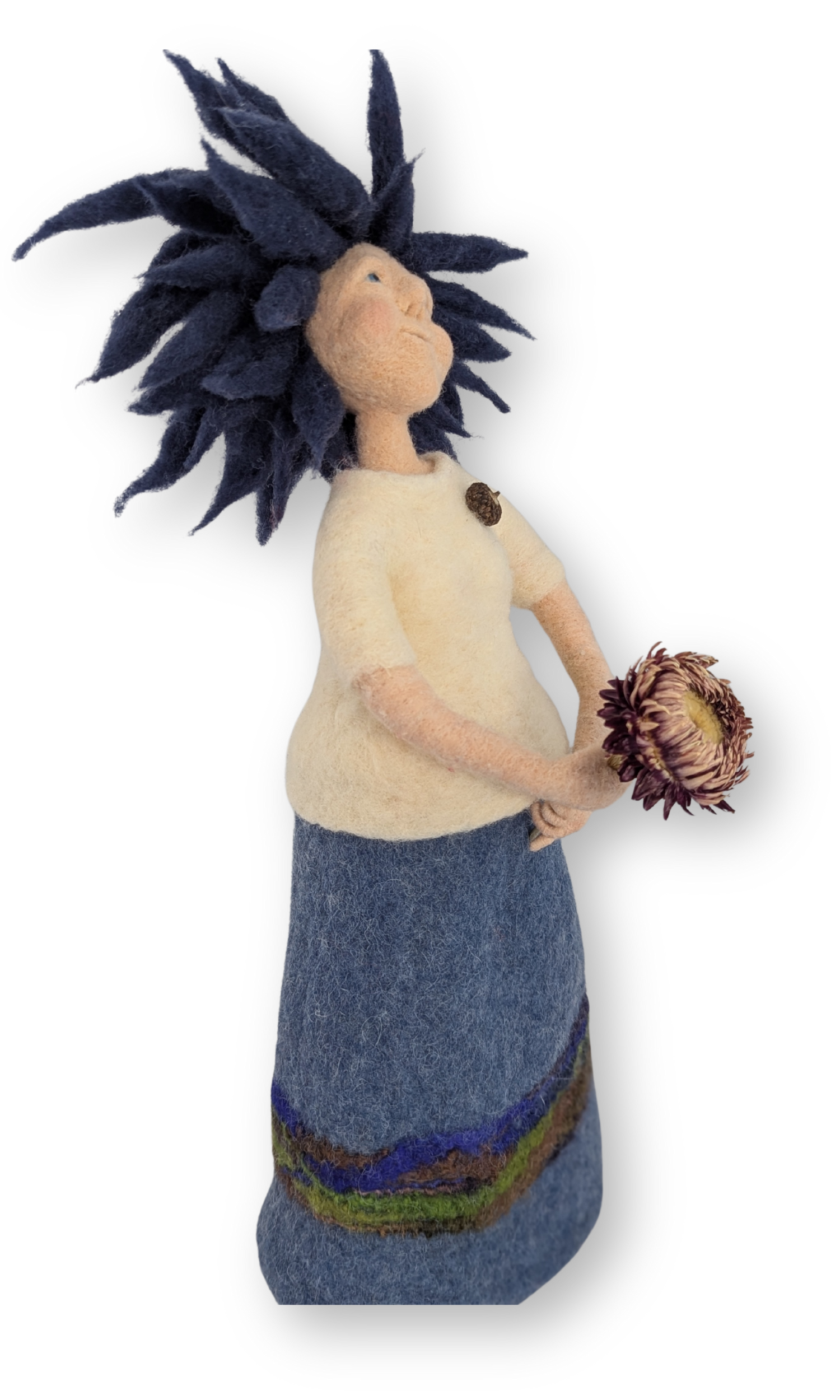 Side view of Dreamer Guardian Doll holding a flower, showcasing the soft felt textures of her clothing and hair.