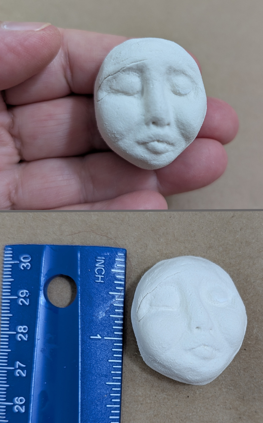 Two-photo image of a small handmade paper-clay starter face with an elongated shape, shown held in hand above and beside a ruler below for size reference.