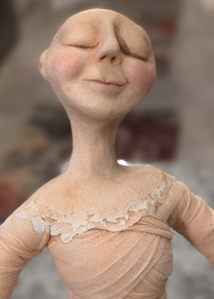 Serene sculpted clay face with closed eyes used for a spirit doll.