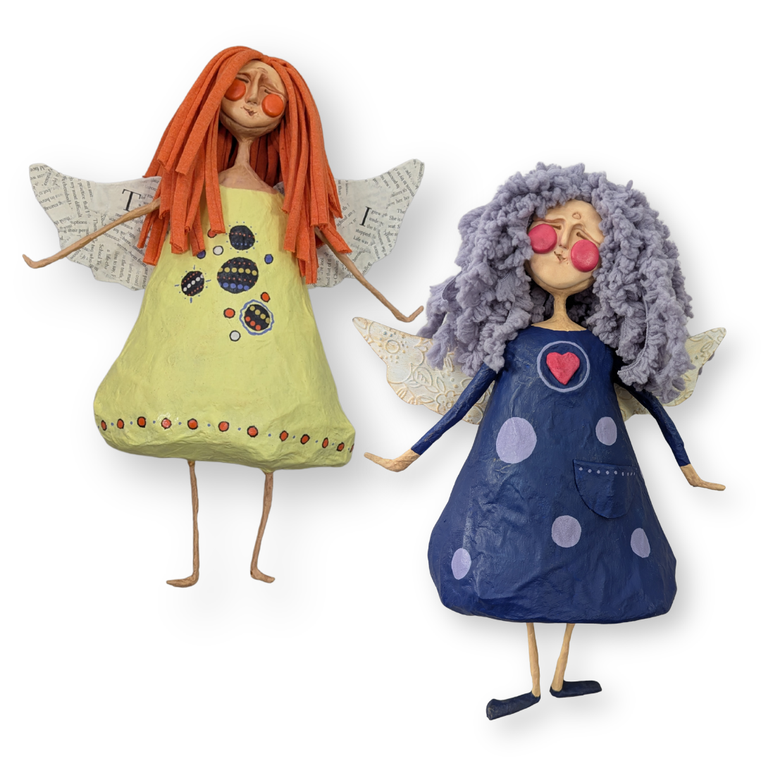 Two finished papier-mâché angels with handmade clay faces, paper wings, colorful painted dresses, and yarn hair.